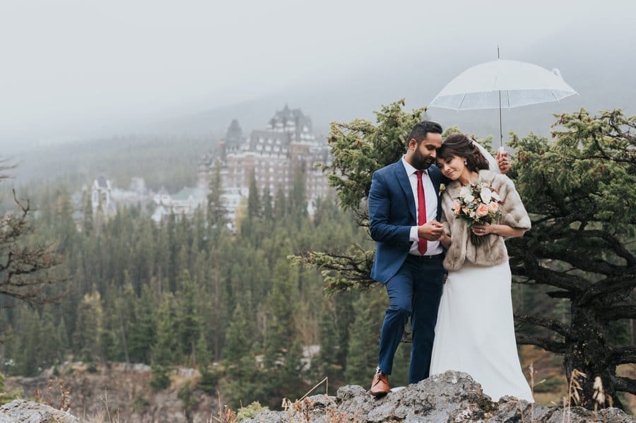 Surprise Corner bride & groom portraits in the rain with umbrellas