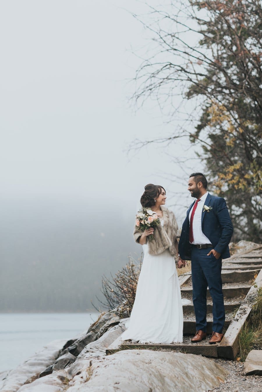 Lake Minnewanka bride & groom portraits in the rain autumn mountain wedding