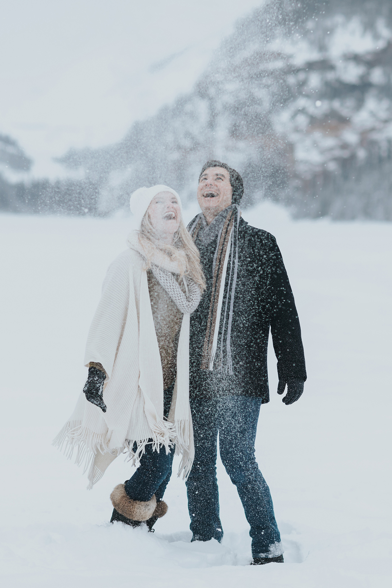 couples session playing in the snow during a winter wonderland in the Canadian Rocky mountains