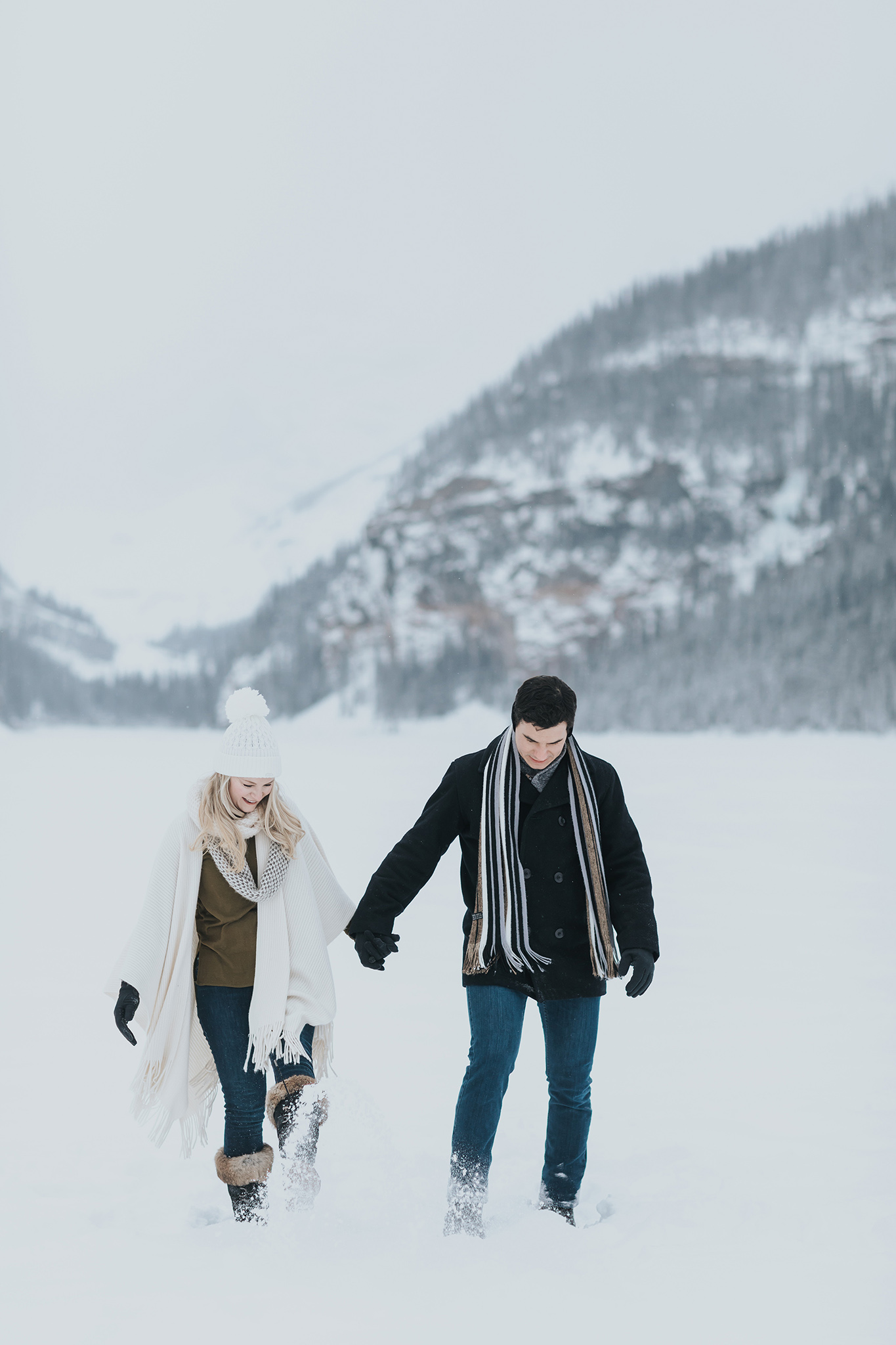 couples session playing in the snow during a winter wonderland in the Canadian Rocky mountains