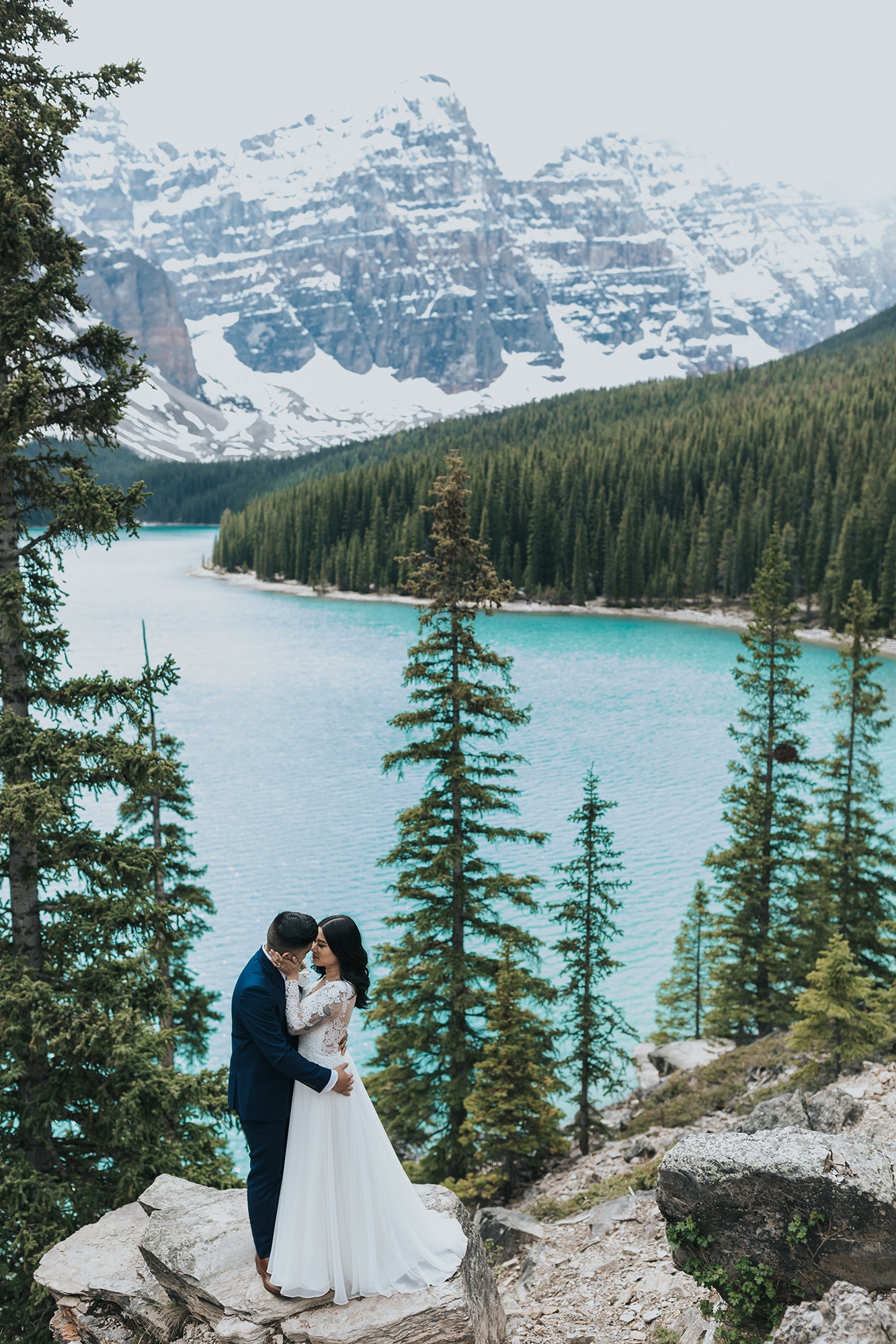 mountain wedding in late spring at the Rock Pile in Moraine Lake with snowy mountains & turquoise water