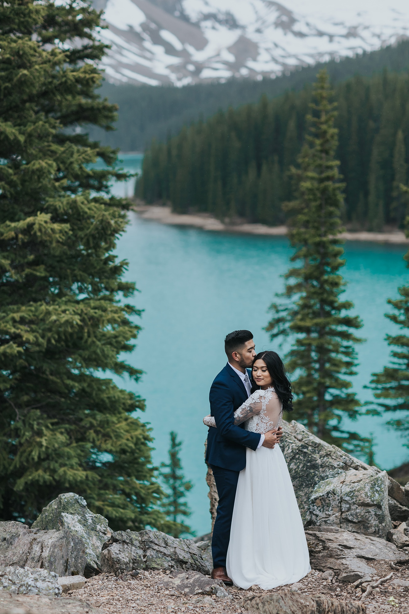 mountain wedding in late spring at the Rock Pile in Moraine Lake with snowy mountains & turquoise water