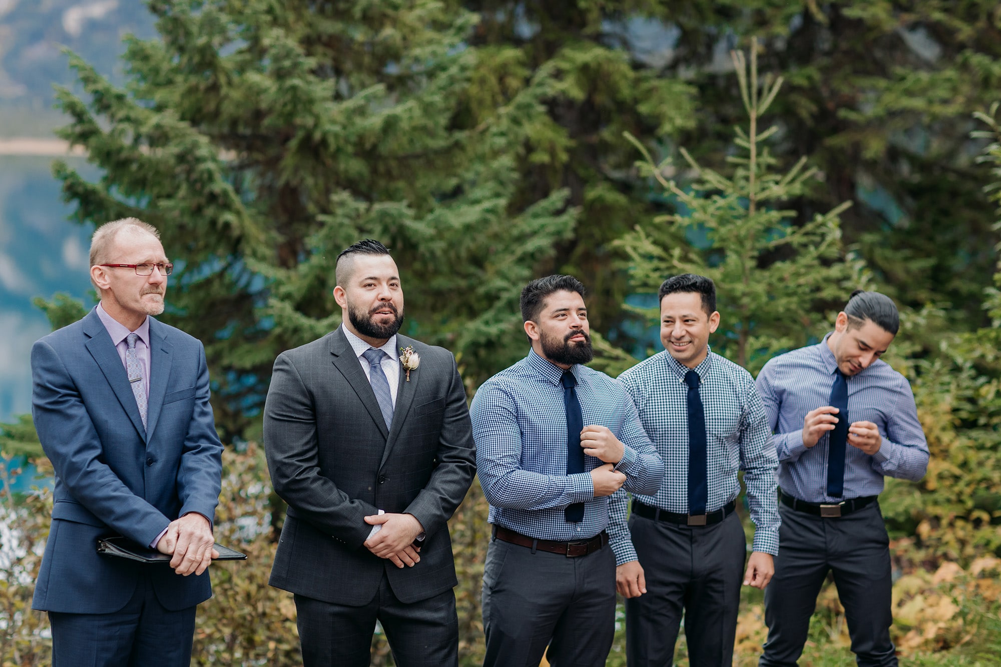 viewpoint outdoor ceremony in the mountains in Yoho National Park in autumn groomsmen & groom waiting for bride