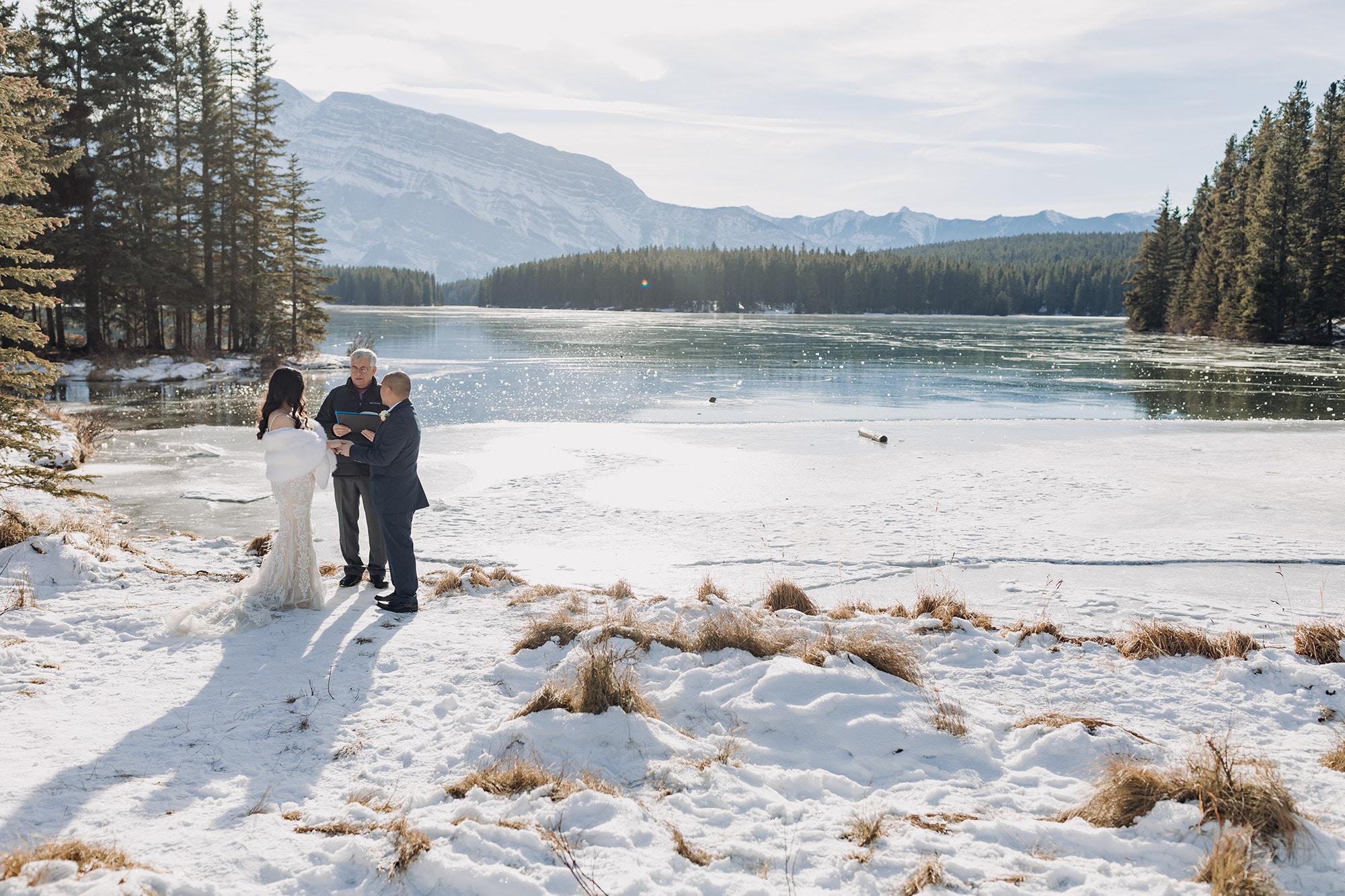 outdoor wedding ceremony overlooking sparkly frozen Two-Jack Lake