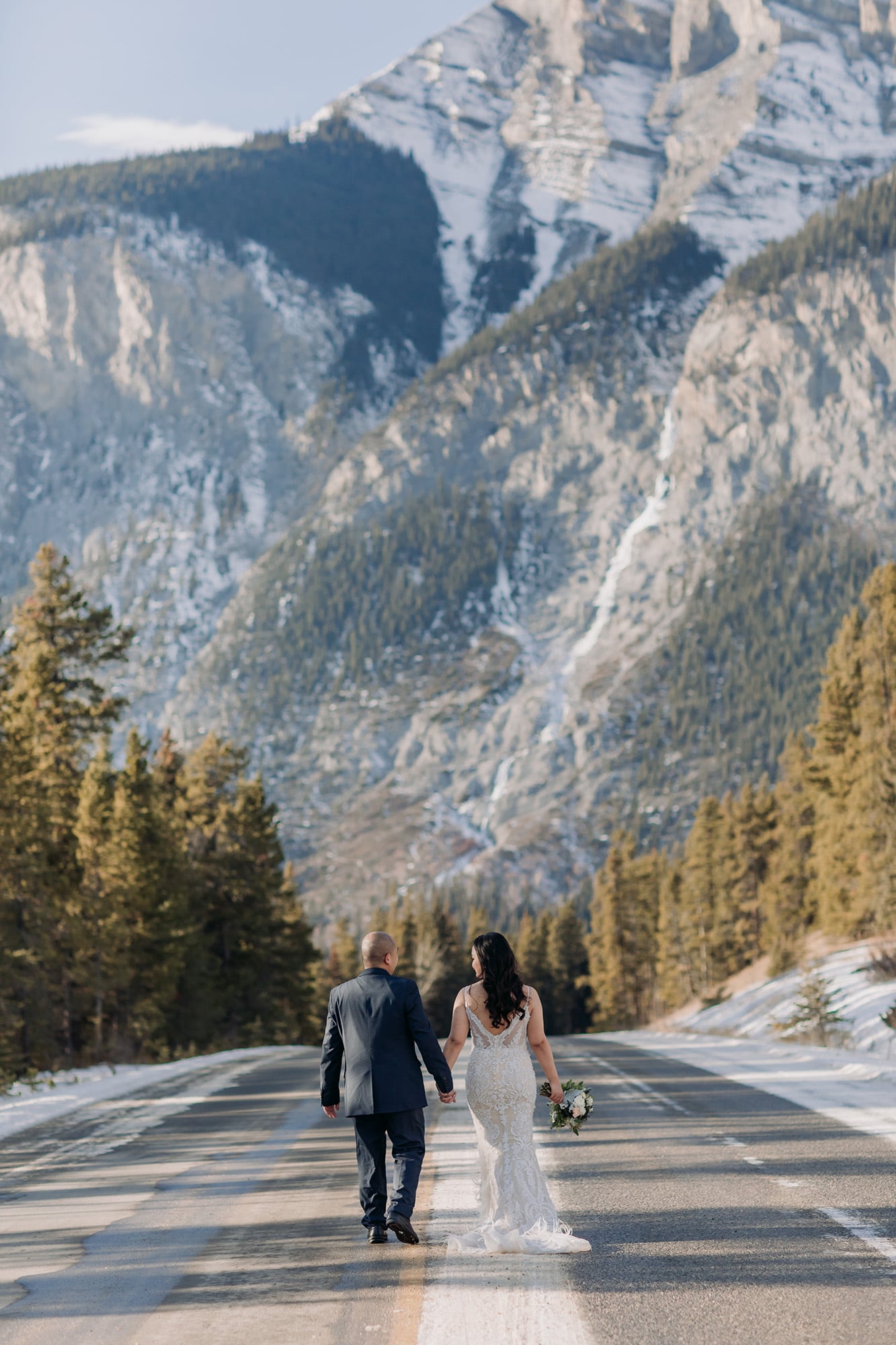 wedding photos in the road with Cascade Mountain in the distance