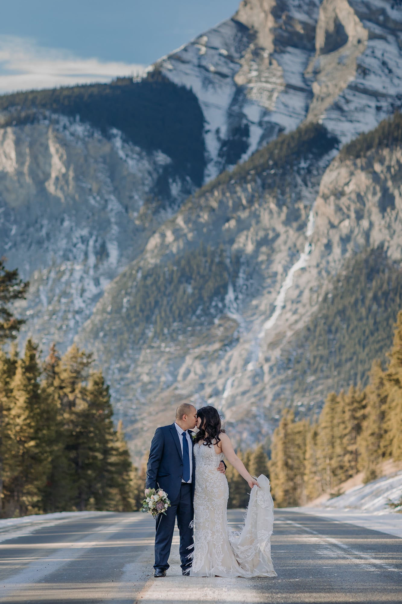 wedding photos in the road with Cascade Mountain in the distance