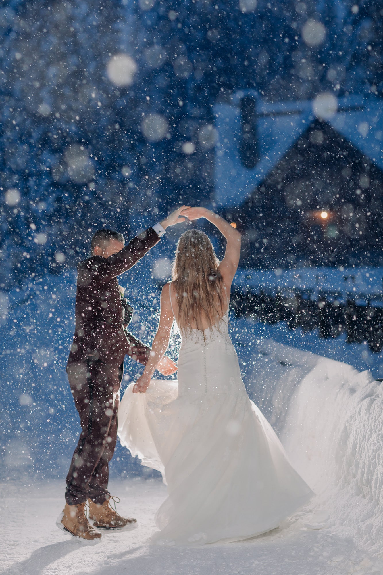 magical winter wonderland wedding portraits night emerald lake lodge twilight snow twirling dancing