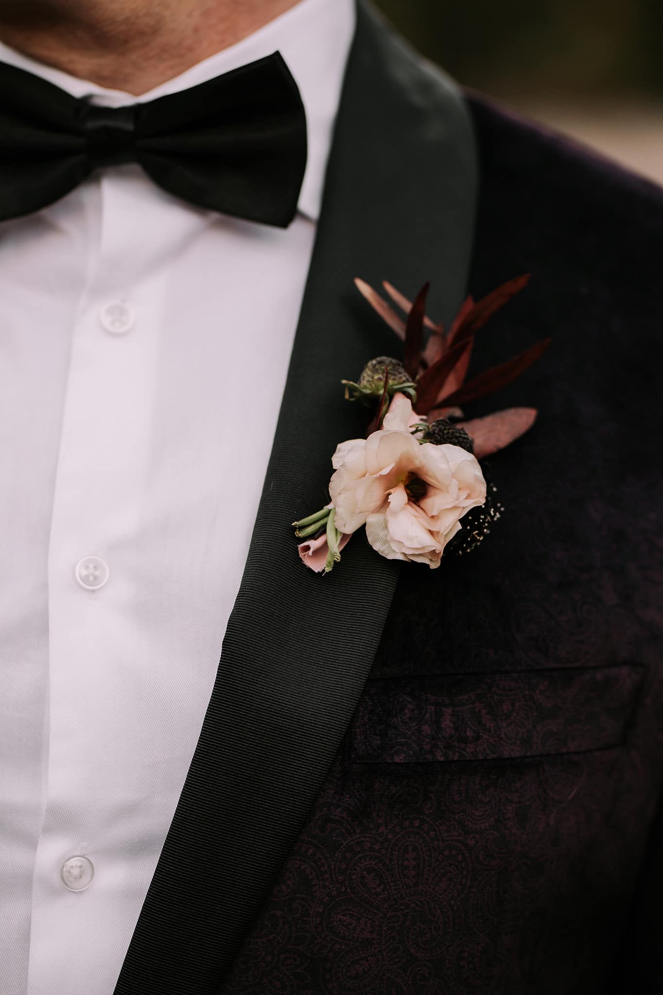 dark moody wedding details inspiration boutonniere white burgundy