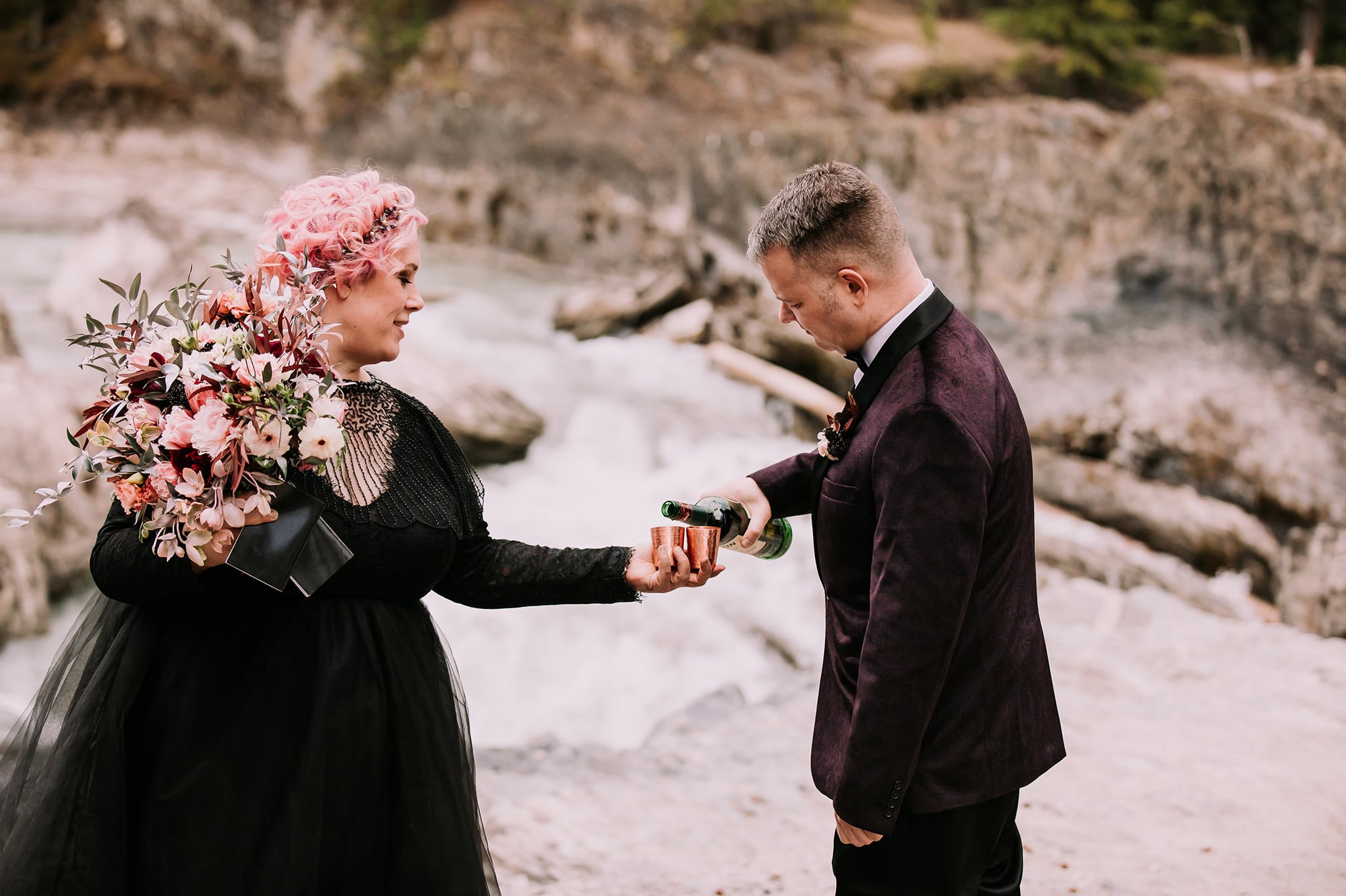 dream mountain vow renewal natural bridge yoho national park bride in black wedding gown pouring shots in of jameson in copper shop glasses