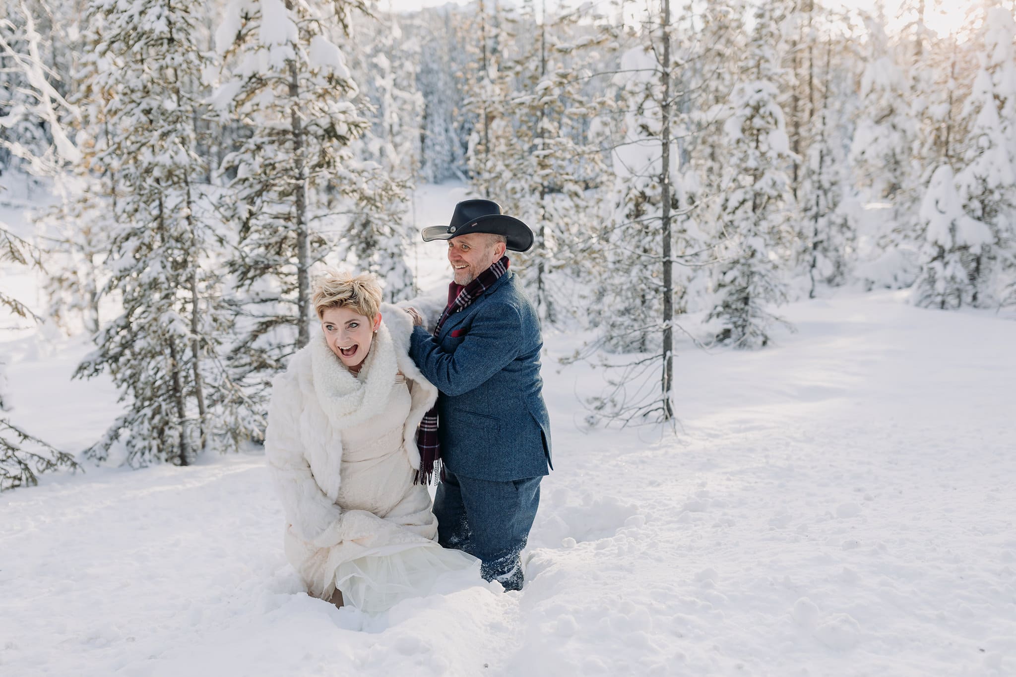 Emerald Lake Lodge winter elopement bride climbing in deep snow