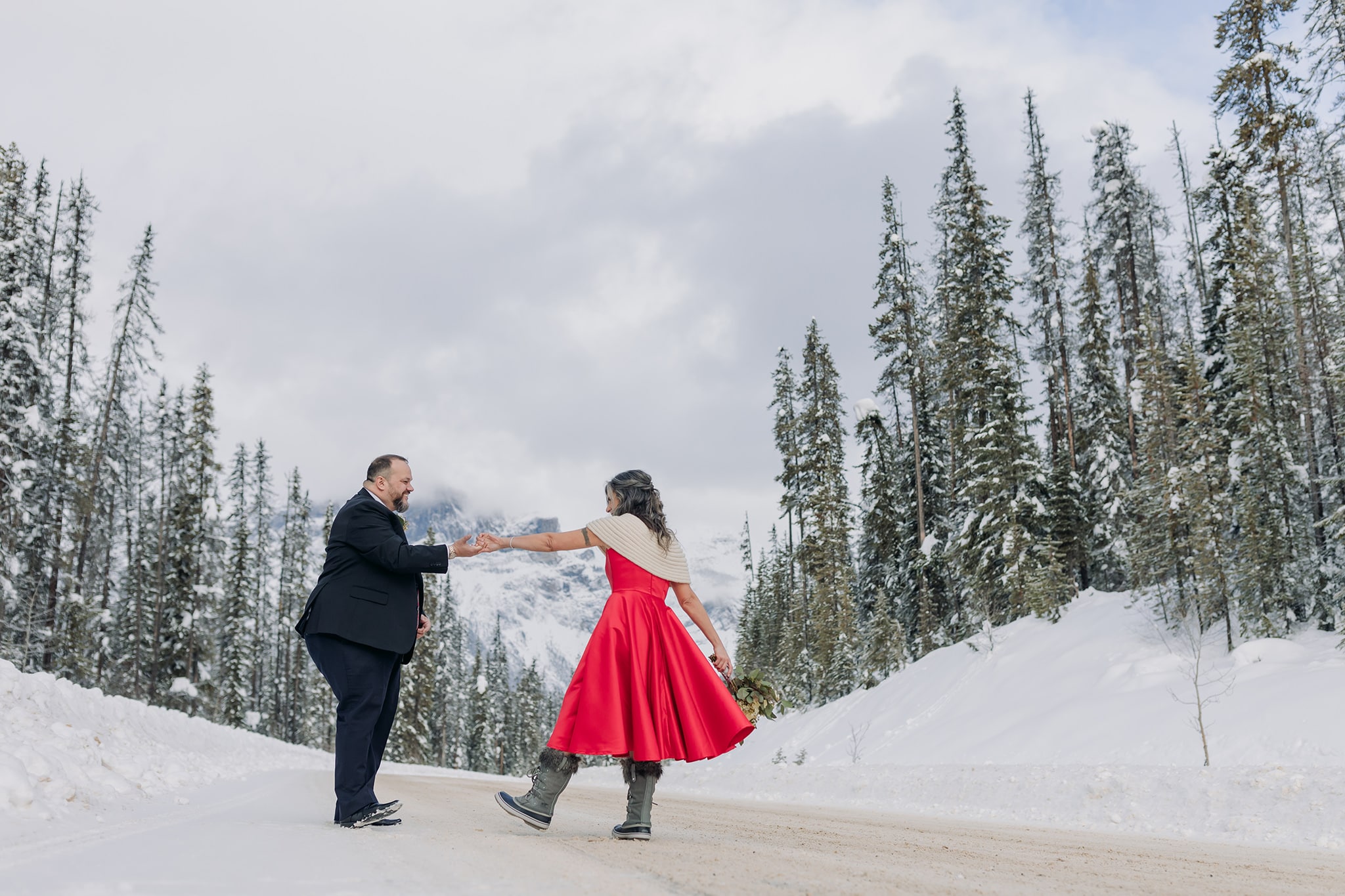 Emerald Lake Lodge Winter elopement bridal groom wedding portraits dancing in the street