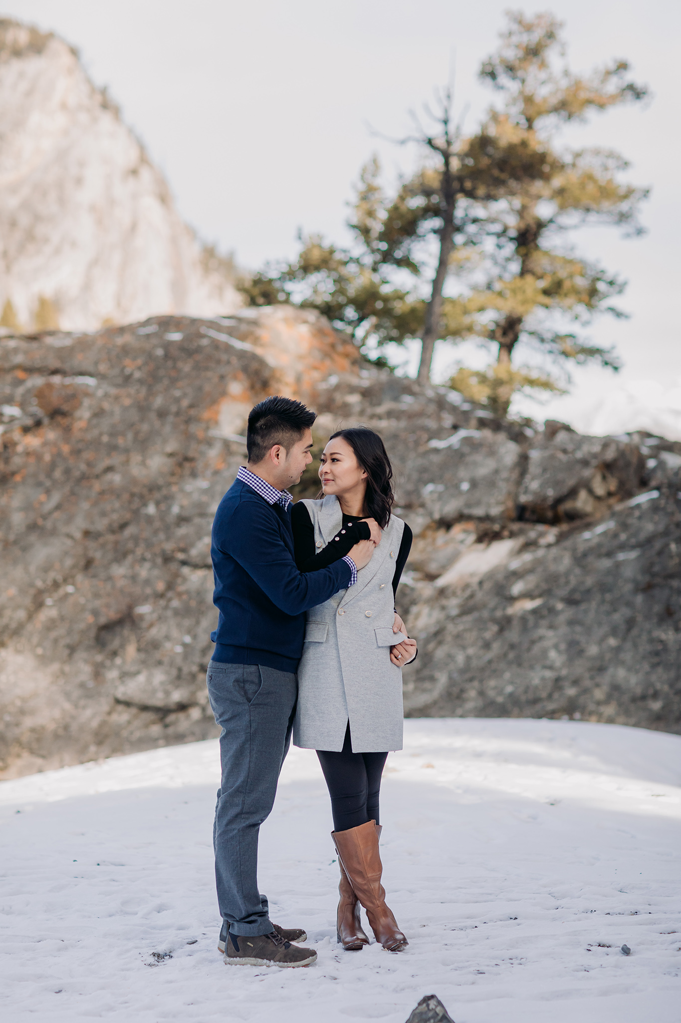 Banff National Park early winter November engagement session on a windy day at Bow Falls