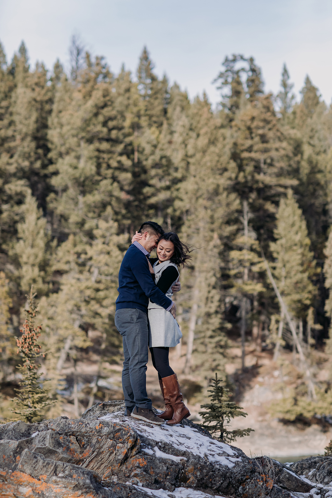 Banff National Park early winter November engagement session on a windy day at Bow Falls