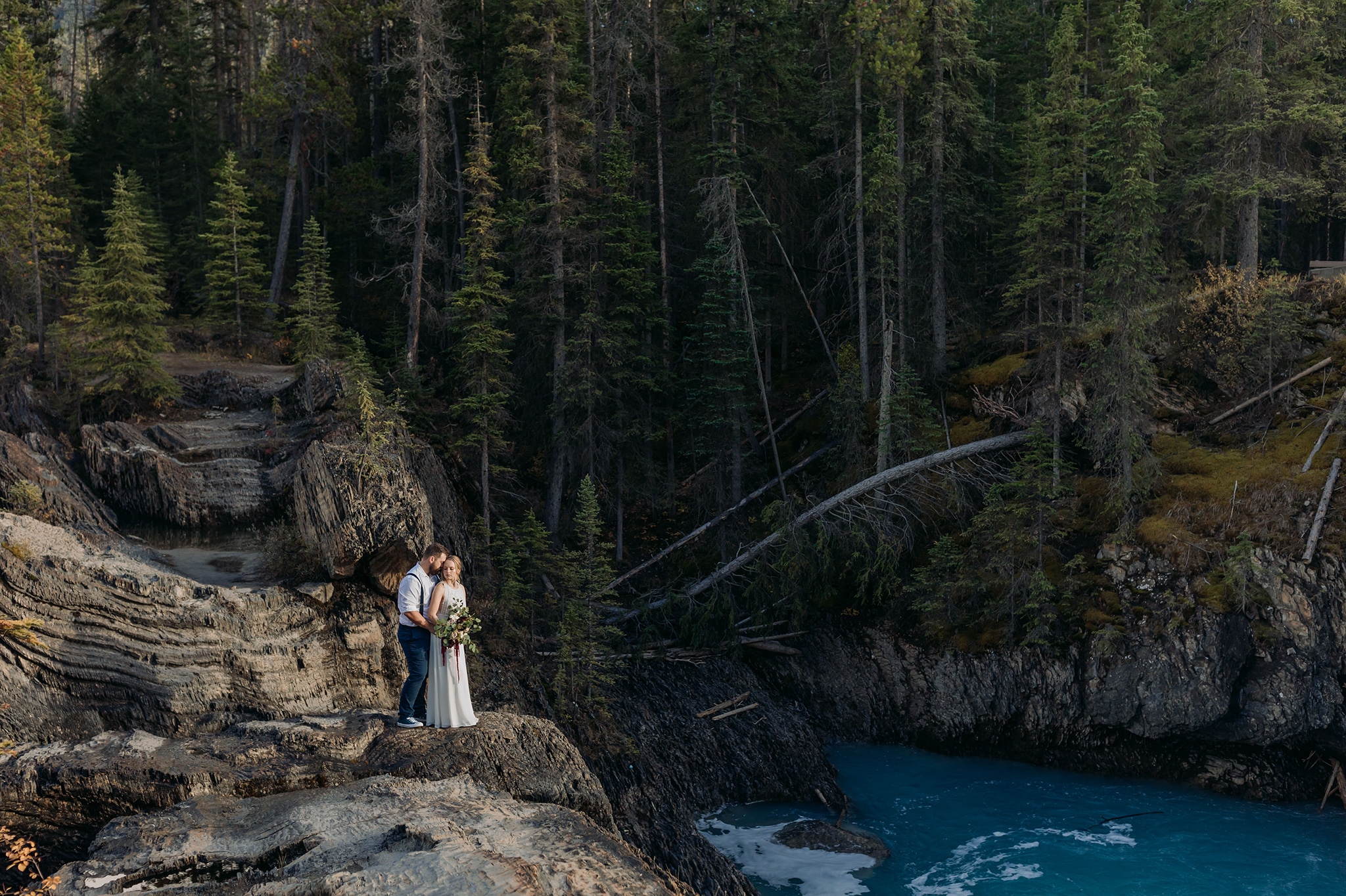 A Guide to Eloping in the Canadian Rockies | Mountain Wedding photographed by ENV Photography | couple at natural bridge in Yoho National Park