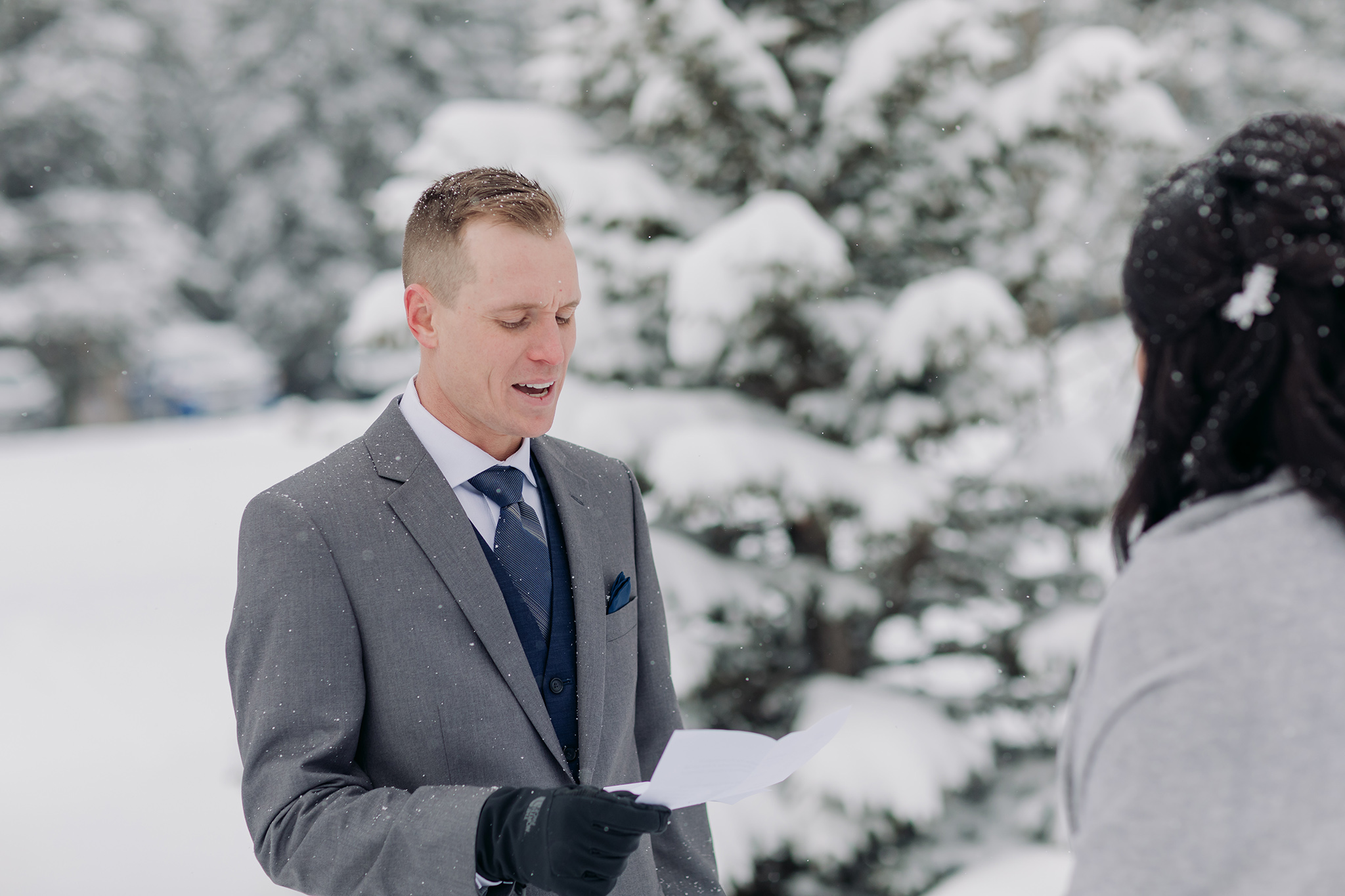 Cascade Ponds winter wedding outdoor ceremony in a snow storm in Banff National Park in the Canadian Rocky Mountains photographed by ENV Photography