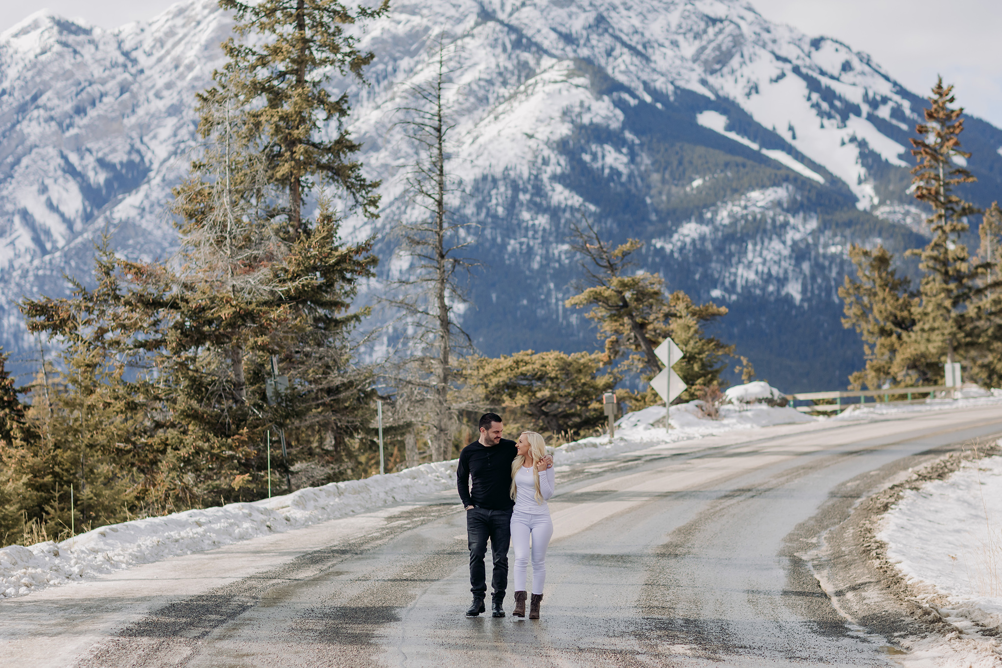 winter mountain vacation couple strolling by Surprise Corner in Banff National Park