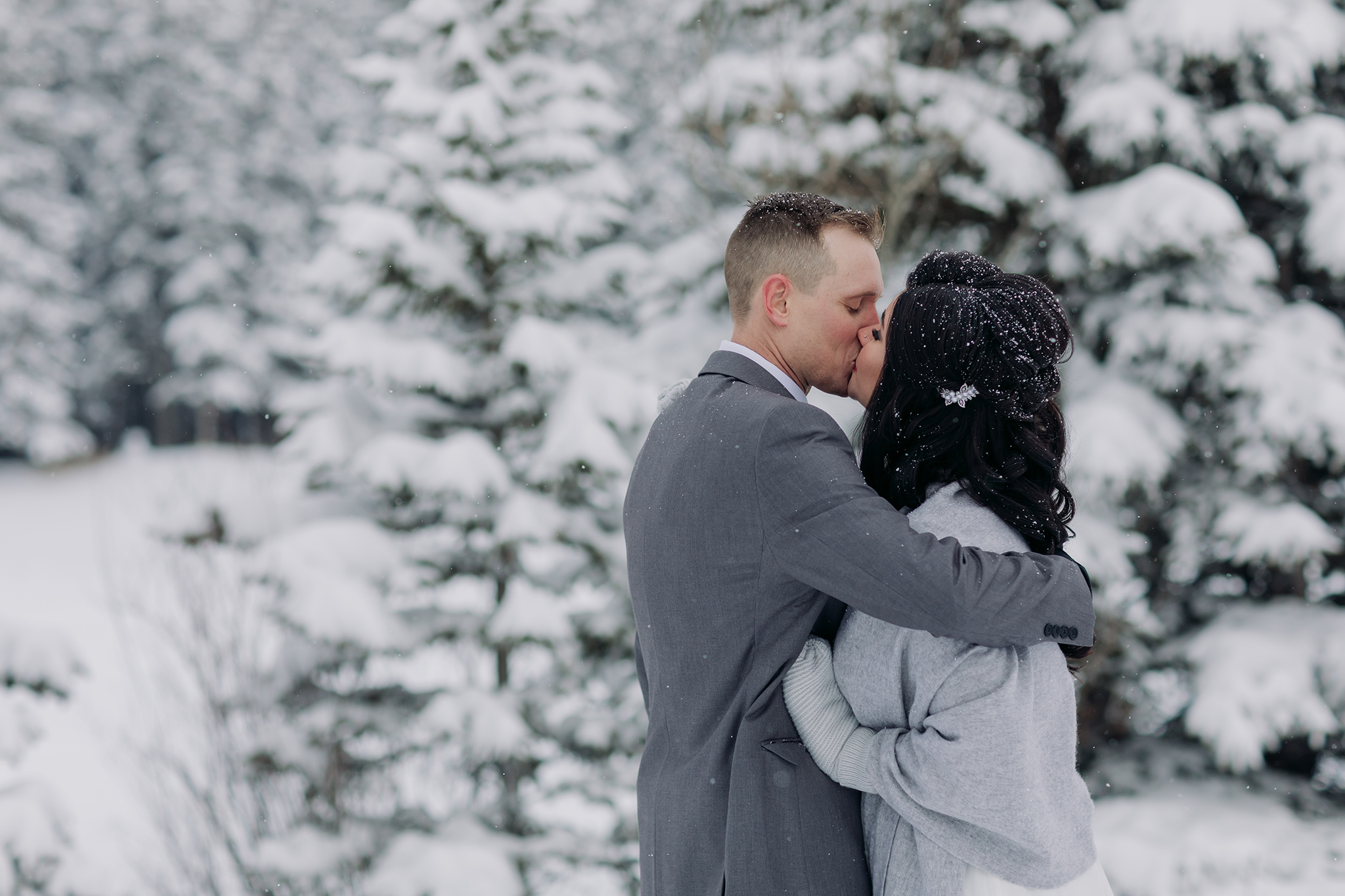Cascade Ponds winter wedding outdoor ceremony in a snow storm in Banff National Park in the Canadian Rocky Mountains photographed by ENV Photography