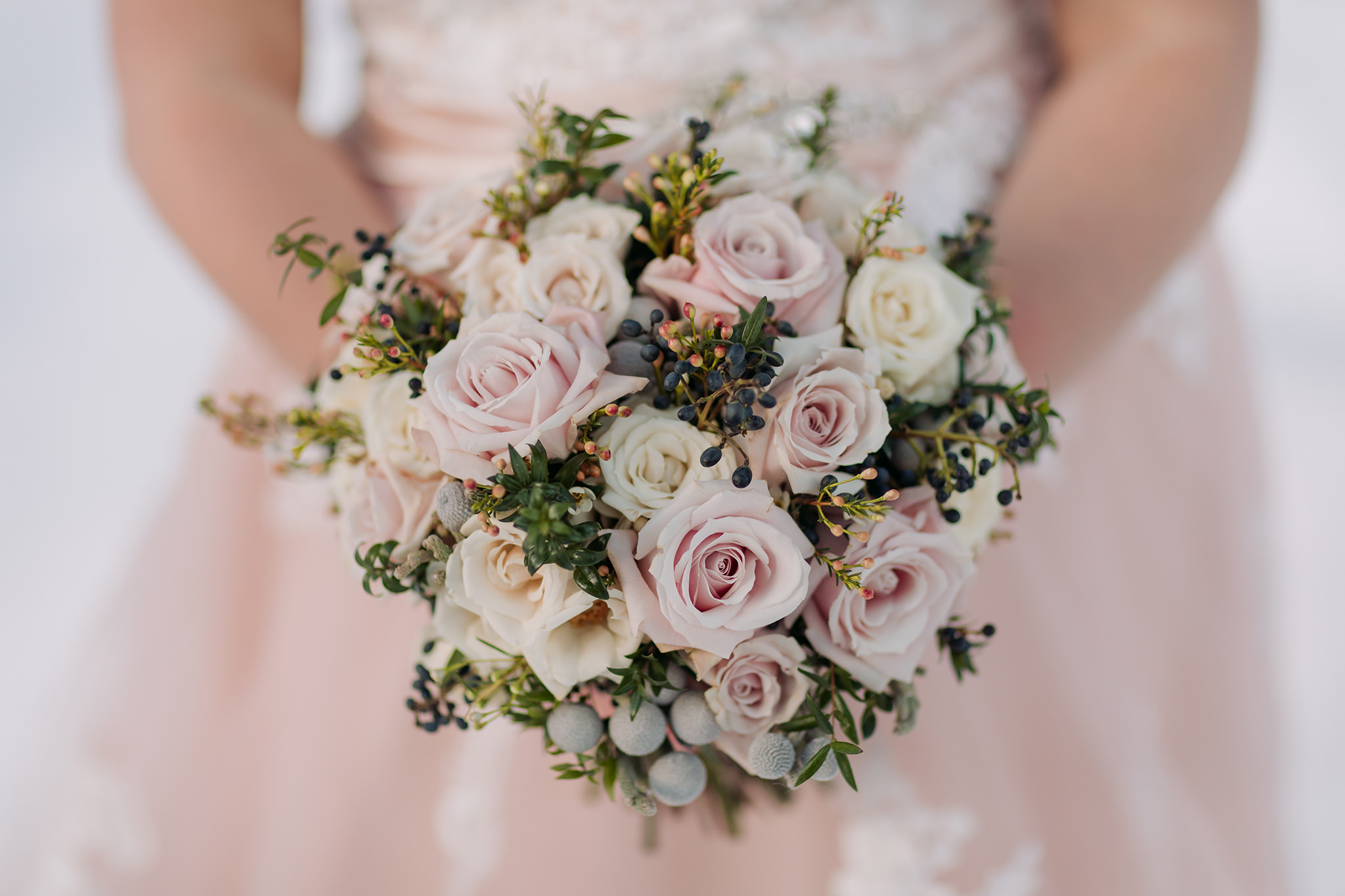 winter wedding bouquet with pink & white roses bride in pink wedding dress Photographed by ENV Photography on Bow Valley Parkway