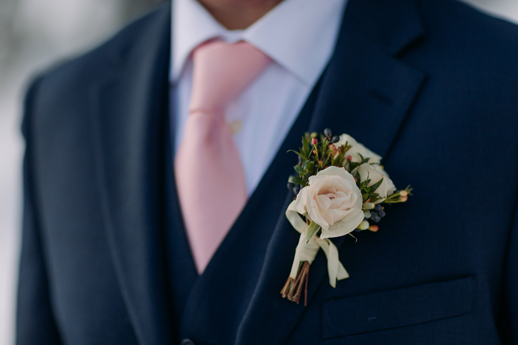 groom in navy suit pink boutonniere winter wedding elopement flowers Photographed by ENV Photography on Bow Valley Parkway
