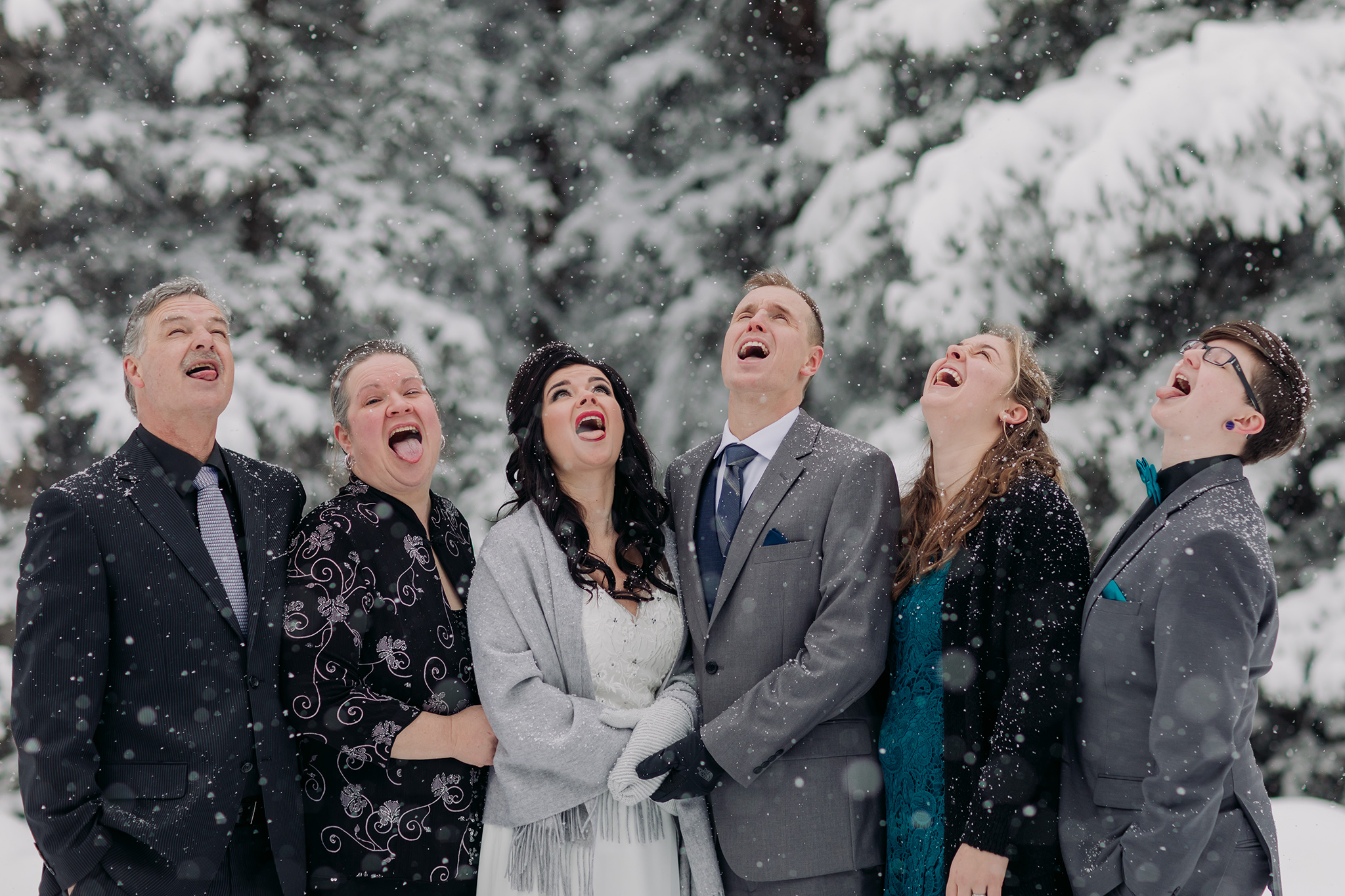 family photos in a snow storm in Banff National Park in the Canadian Rocky Mountains photographed by ENV Photography catching snowflakes