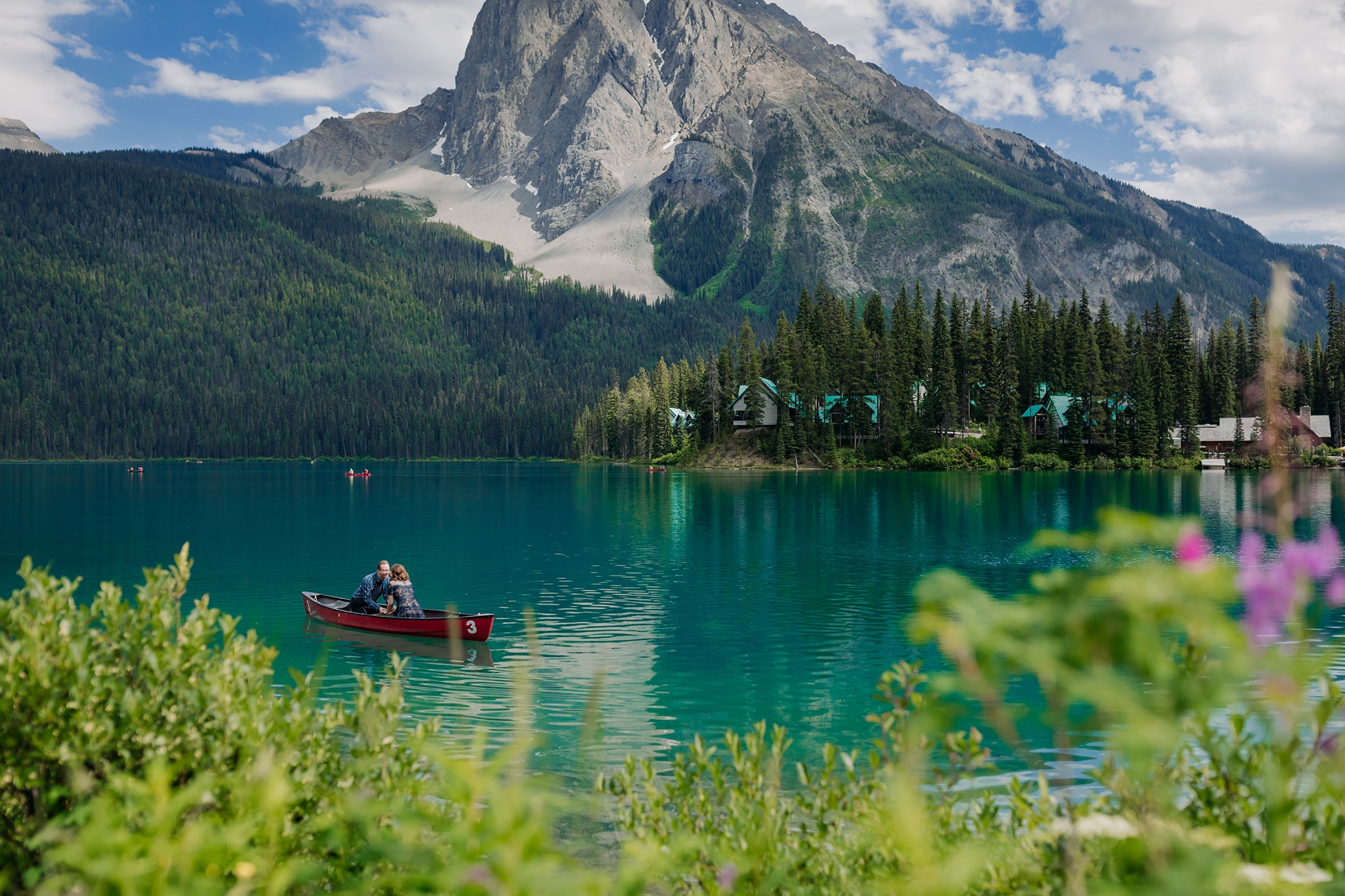 A Guide to Eloping in the Canadian Rockies | Mountain Wedding photographed by ENV Photography | eloping couple in canoe on green waters at Emerald Lake Lodge in the Summer