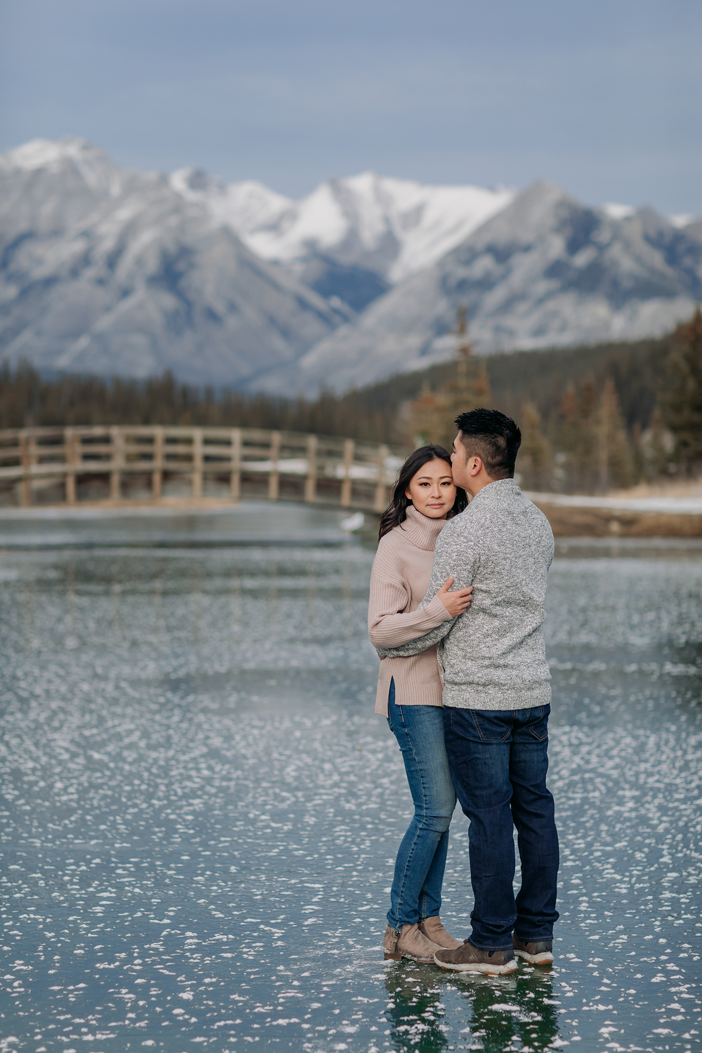 Banff National Park early winter November engagement session on a windy day at Cascade Ponds with rare frost flowers & green Ice