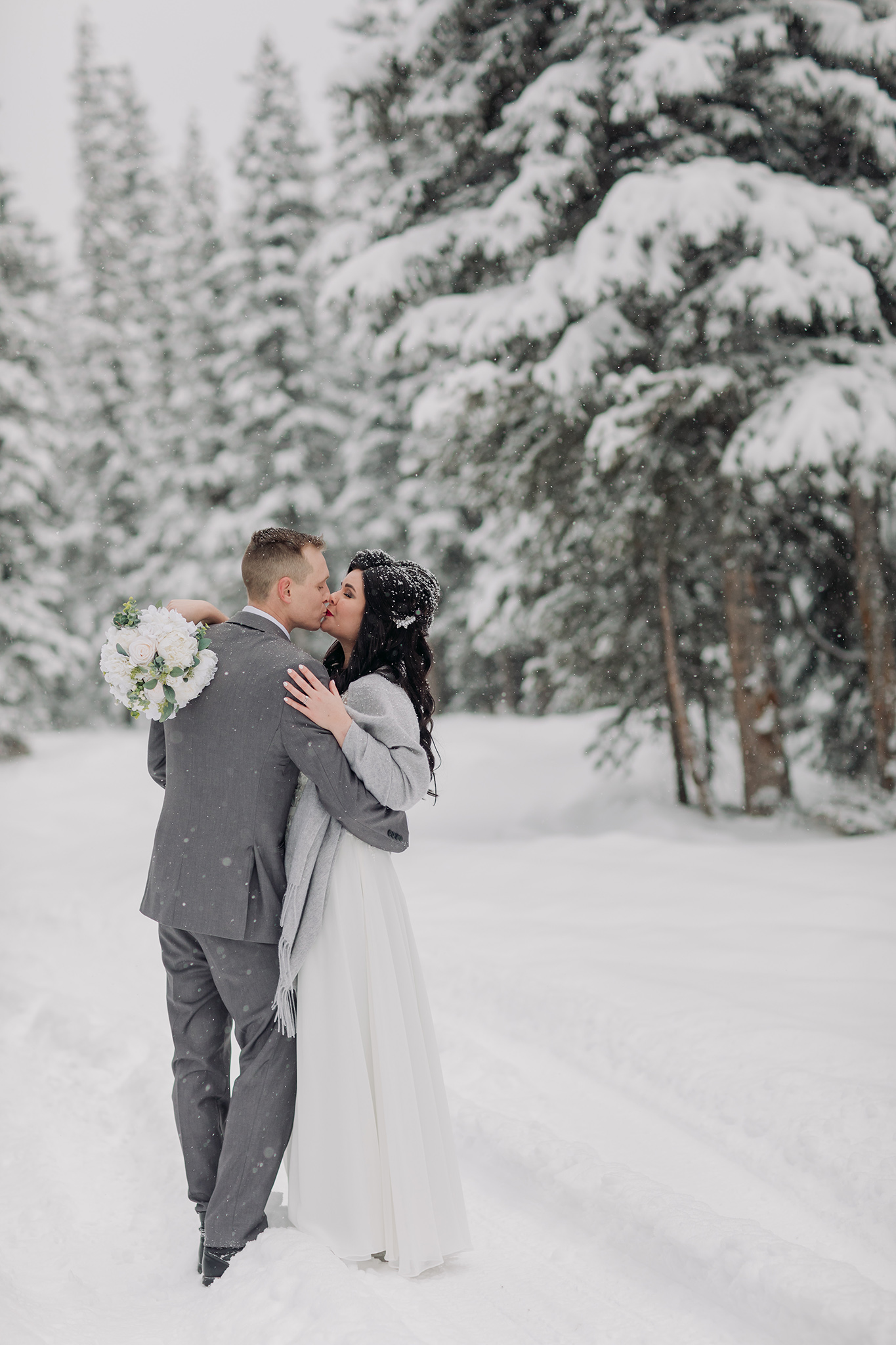 bride groom wedding portraits in a snow storm in Banff National Park in the Canadian Rocky Mountains photographed by ENV Photography