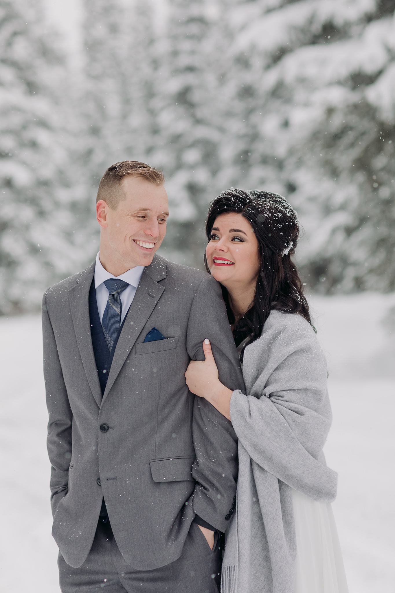 Cascade Ponds winter wedding portraits in a snow storm in Banff National Park in the Canadian Rocky Mountains photographed by ENV Photography