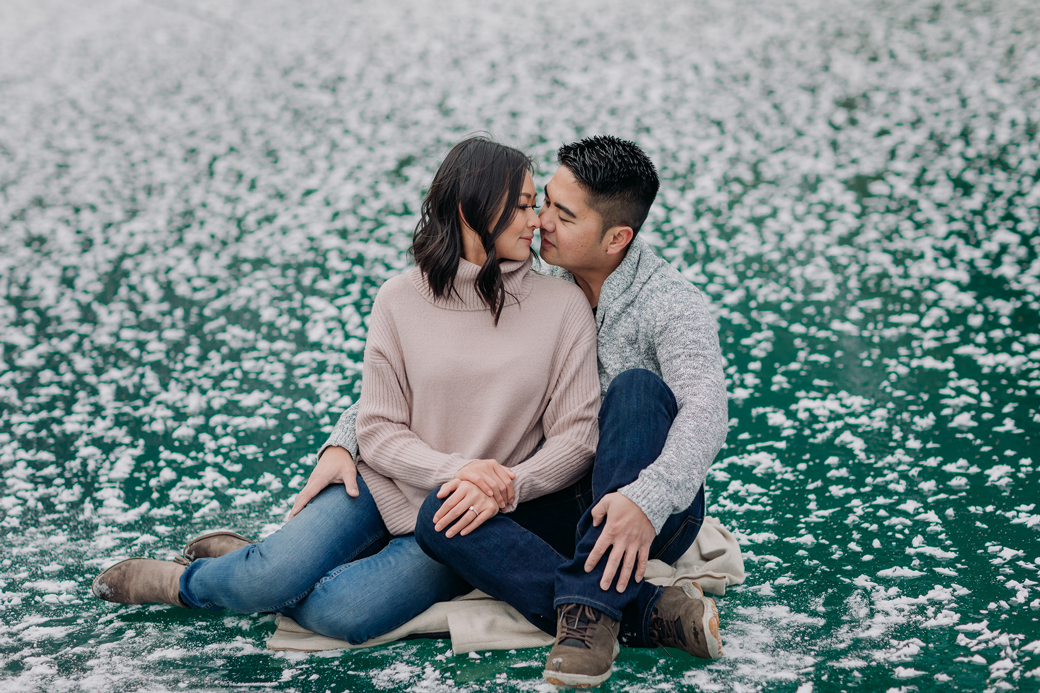 Banff National Park early winter November engagement session on a windy day at Cascade Ponds with rare frost flowers & green Ice