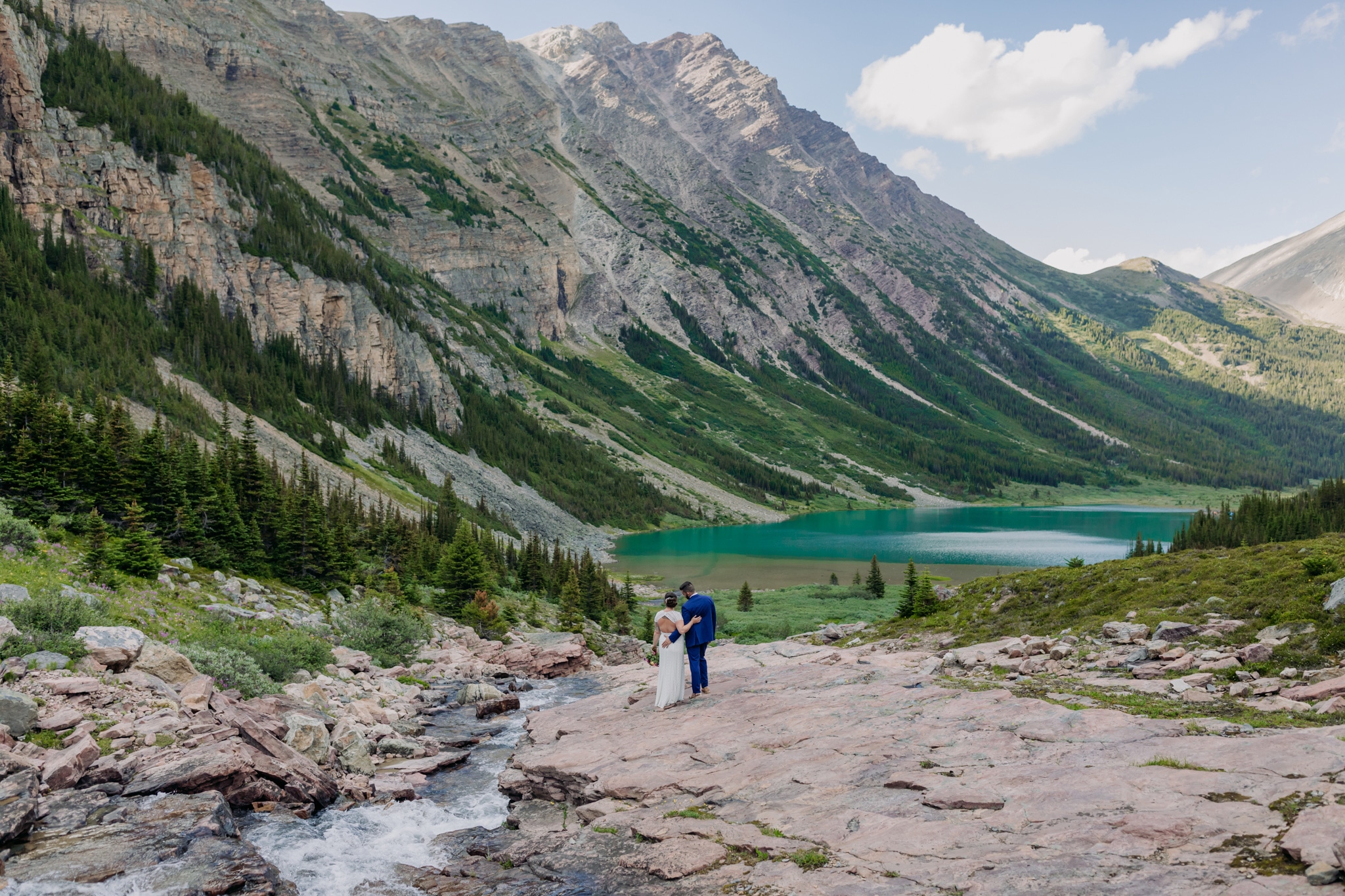 A Guide to Eloping in the Canadian Rockies | Mountain Wedding photographed by ENV Photography | Adventurous helicopter wedding near Cline River & Abraham Lake with Rockies Heli. Lake of the Woods with pink rocks.