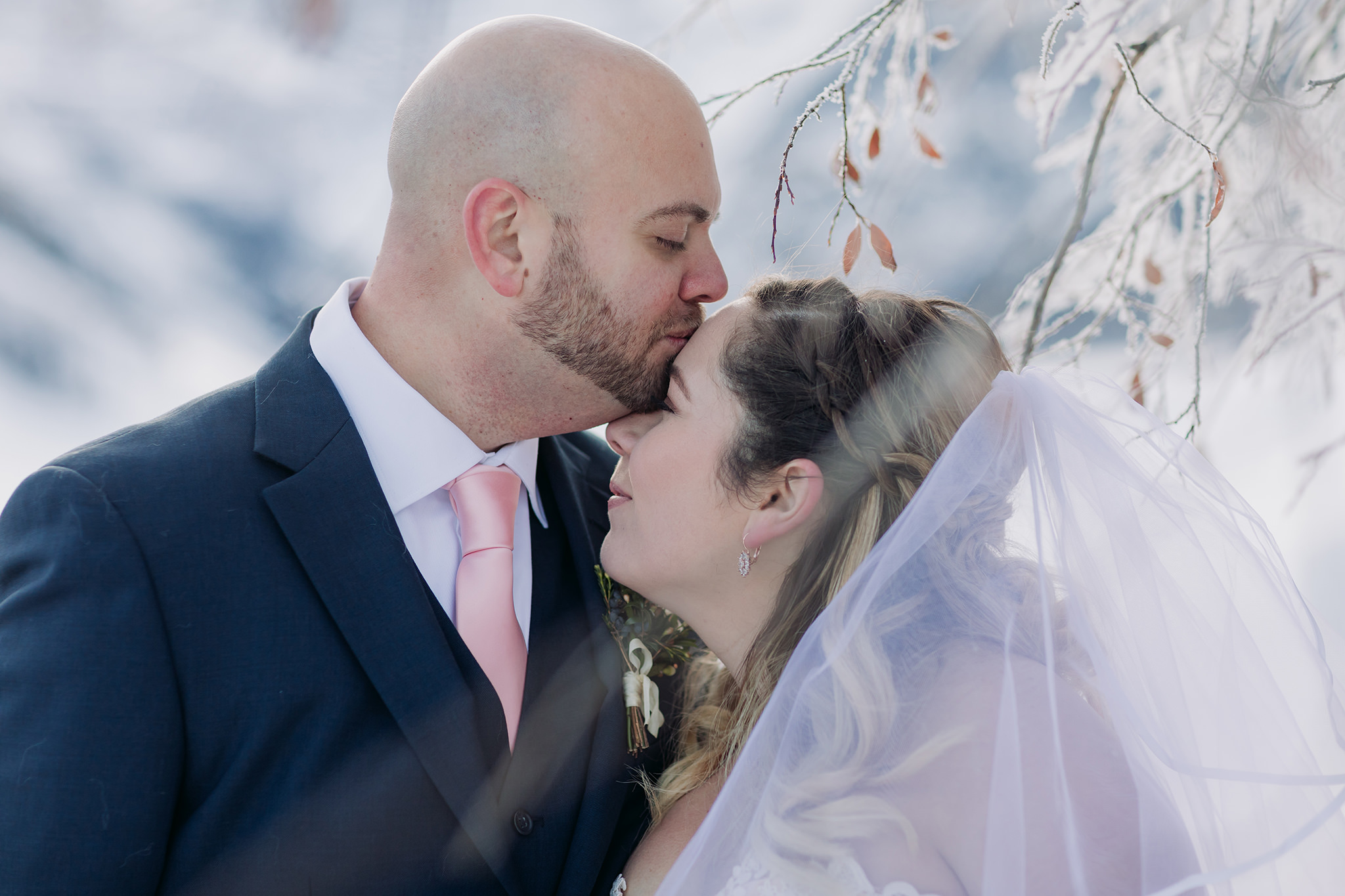Lake Louise winter elopement on frozen Lake Louise with Bride in pink wedding dress in winter wonderland Super snowy elopement wedding photographed by ENV Photography Bow Valley Parkway