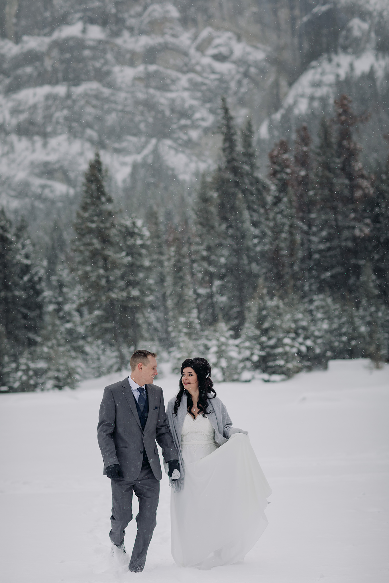 bride groom portraits at Tunnel Mountain Reservoir in a snow storm in Banff National Park in the Canadian Rocky Mountains photographed by ENV Photography