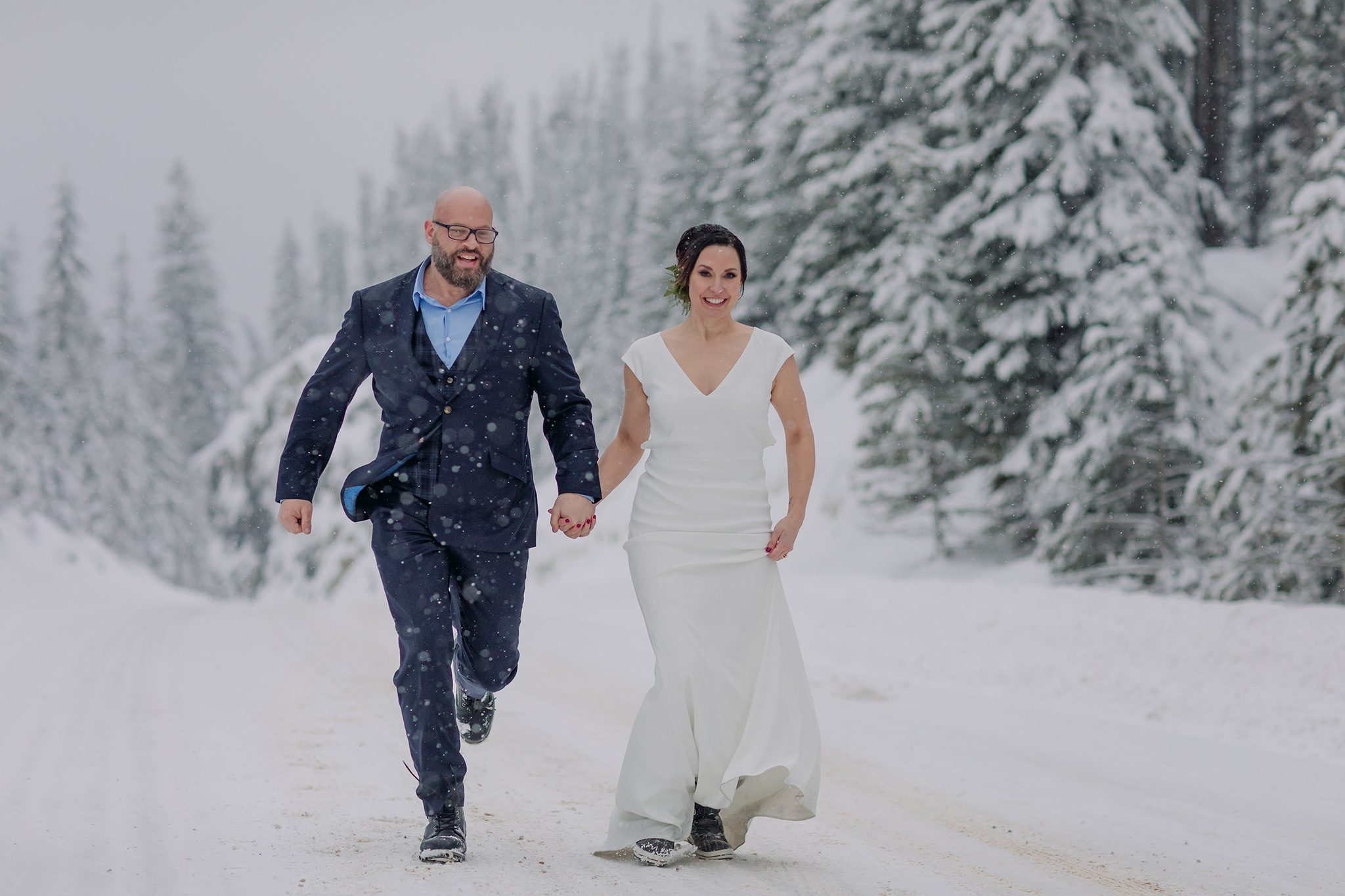 snowy mountain elopement outdoor bride & groom portraits with falling snow photographed by mountain elopement & wedding photographer ENV Photography