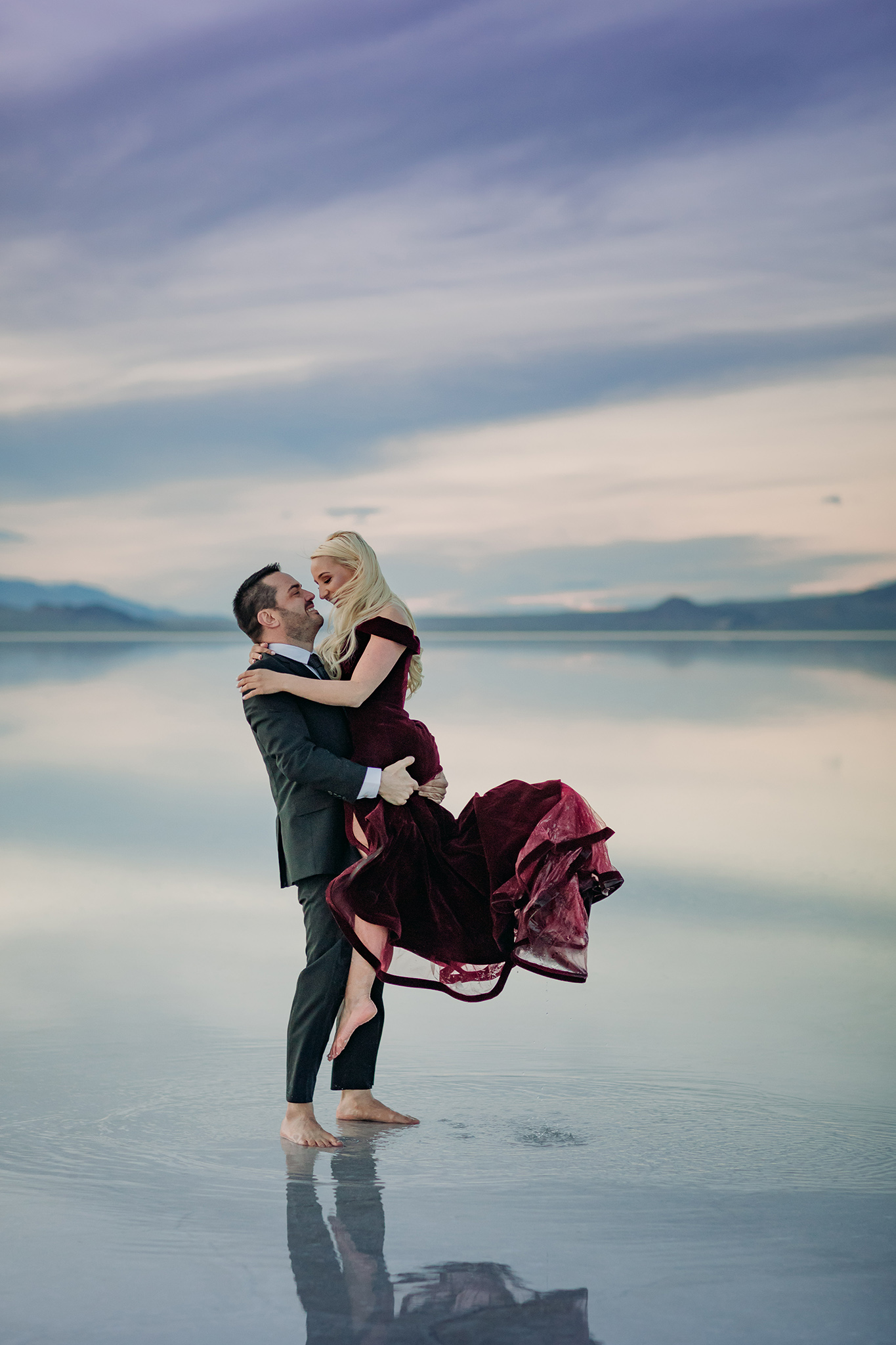 dancing in the water mirror reflections mountain views at sunset in Utah Bonneville Salt Flats