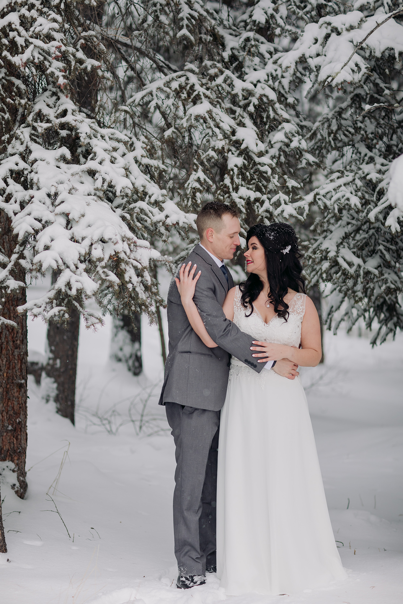 bride groom portraits at Juniper Hotel in a snow storm in Banff National Park in the Canadian Rocky Mountains photographed by ENV Photography