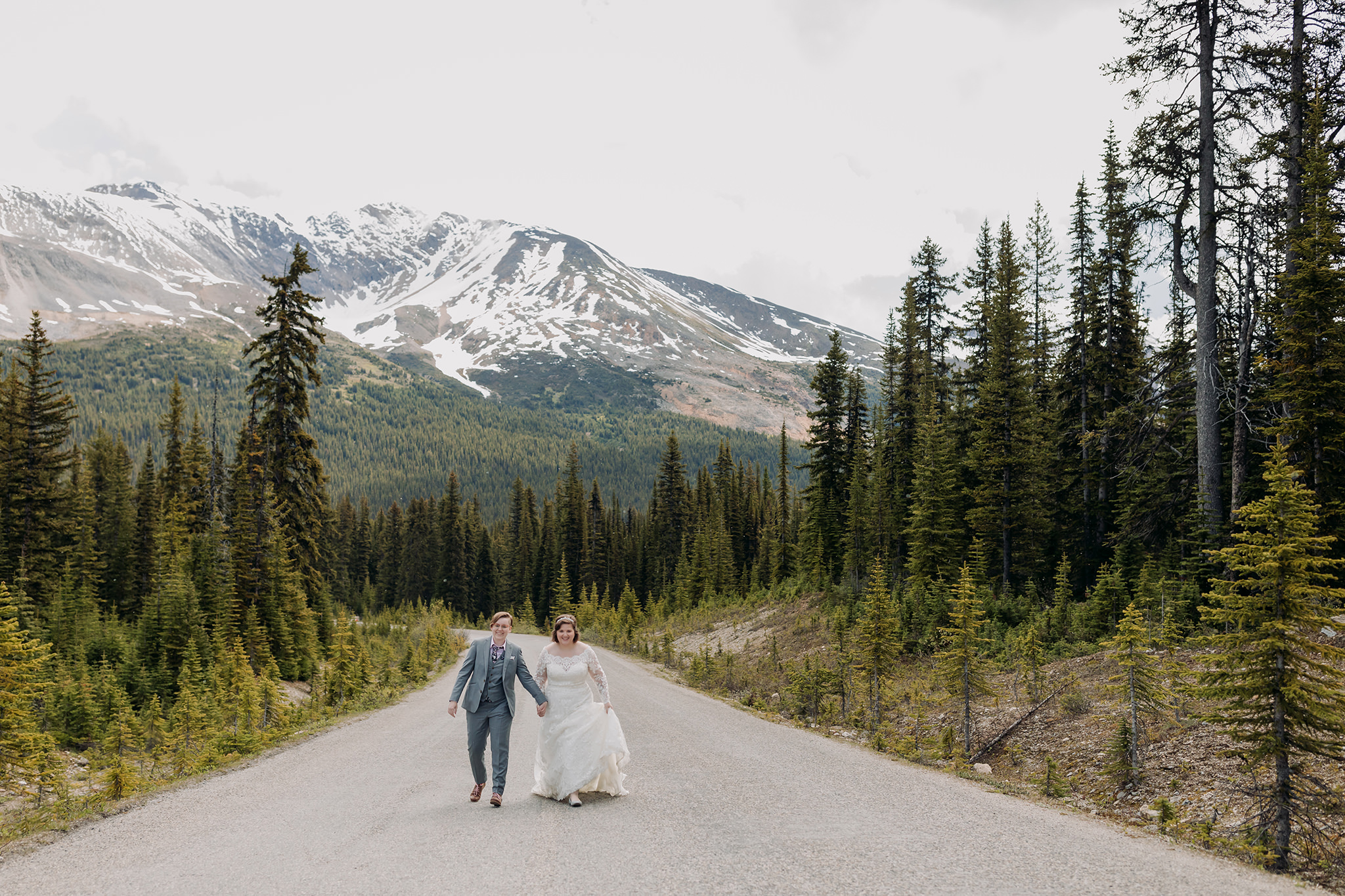 Icefields Parkway adventure session on road to Peyto Lake with same-sex wedding couple days after their wedding. Mountain Wedding portraits photographed by ENV Photography. Gay friendly. LGBTQ friendly wedding & elopement photographer.