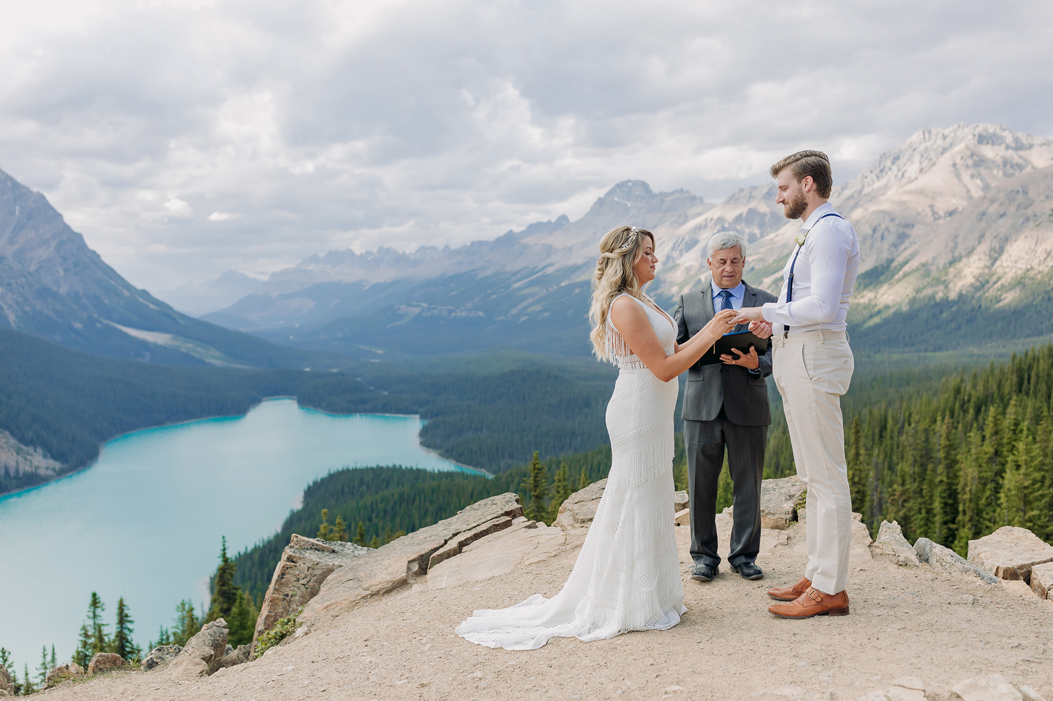Peyto Lake Intimate wedding ceremony on Icefields Parkway surrounded by Mountains overlooking blue mountain Lake in the summer photographed my ENV Photography