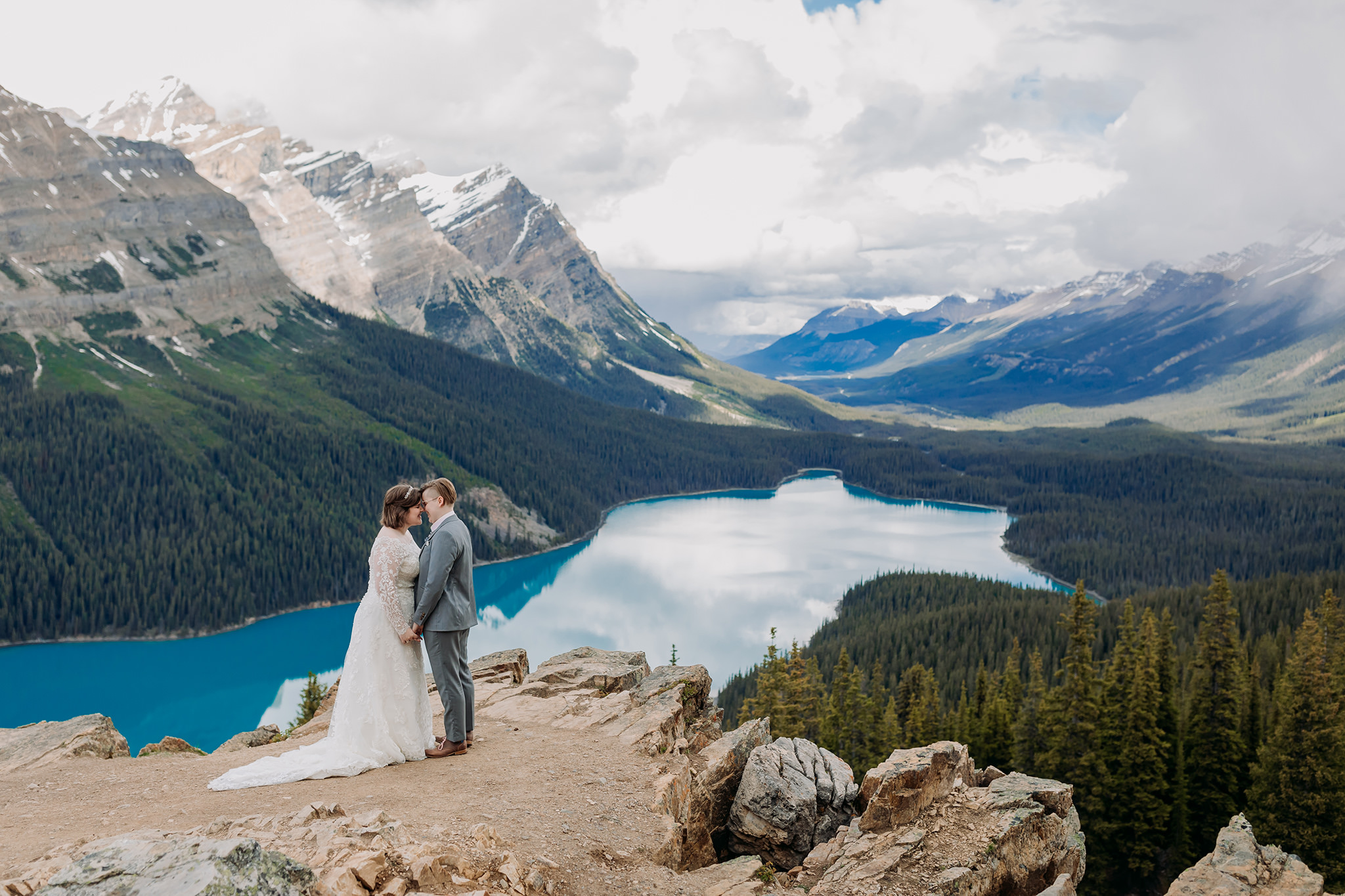 Icefields Parkway adventure session at rocky viewpoint at Peyto Lake with same-sex wedding. Mountain Wedding portraits photographed by ENV Photography. Gay friendly. LGBTQ friendly wedding & elopement photographer.