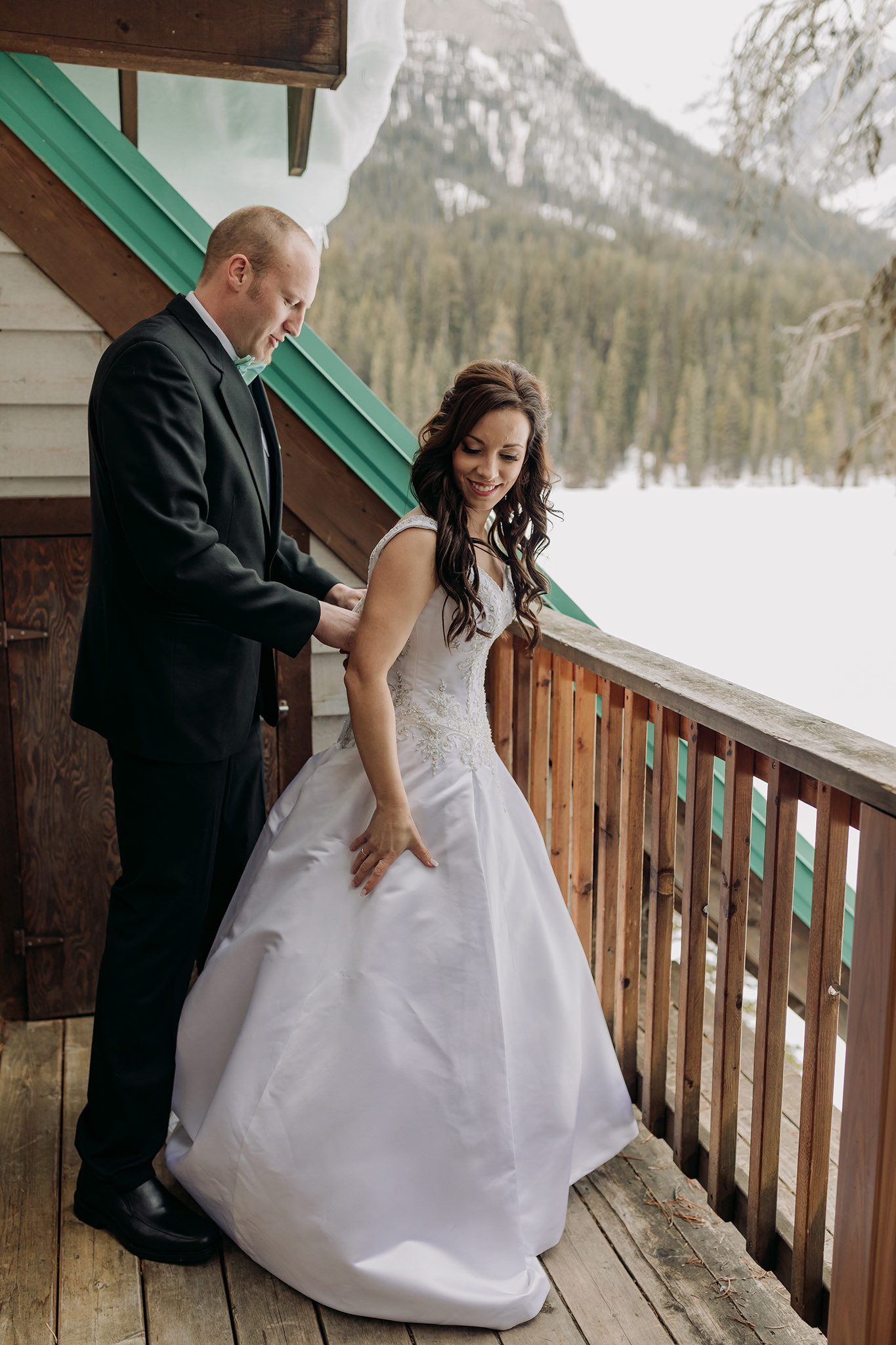 Emerald Lake Lodge elopement bride & groom getting ready together in rustic cabin for spring mountain elopement