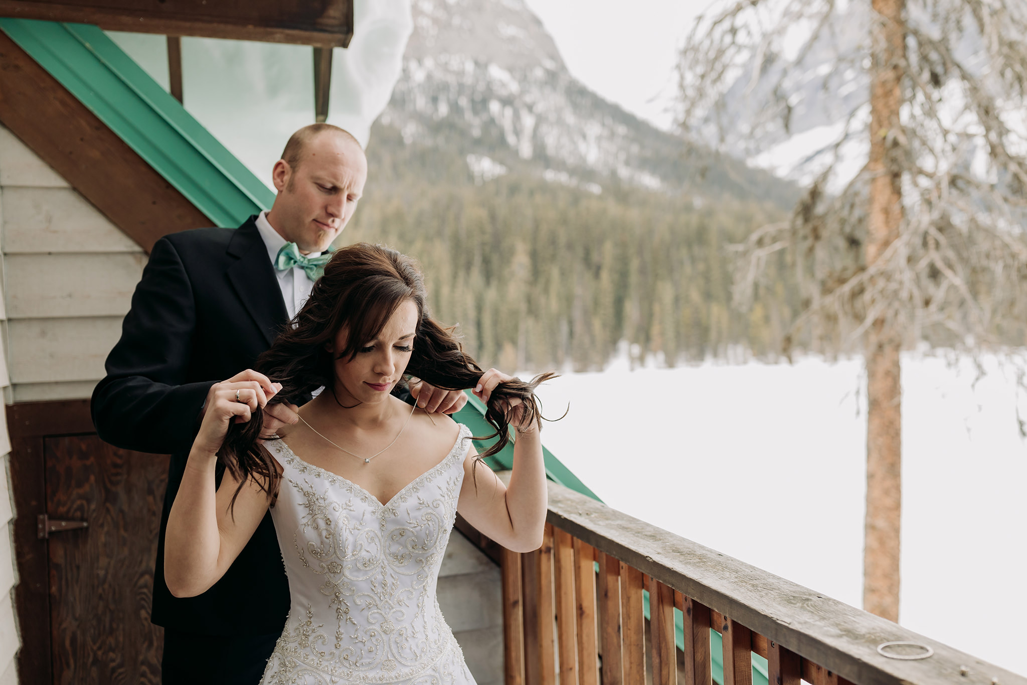 Emerald Lake Lodge elopement bride & groom getting ready together in rustic cabin for spring mountain elopement