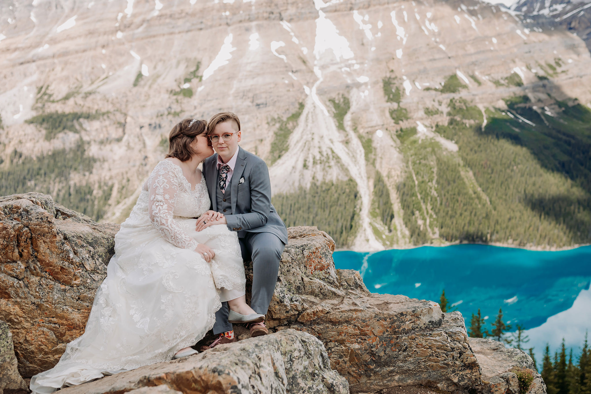 Post-wedding portraits rocky viewpoint at Peyto Lake. same-sex wedding. Mountain Wedding portraits photographed by ENV Photography. Gay friendly. LGBTQ friendly wedding & elopement photographer.