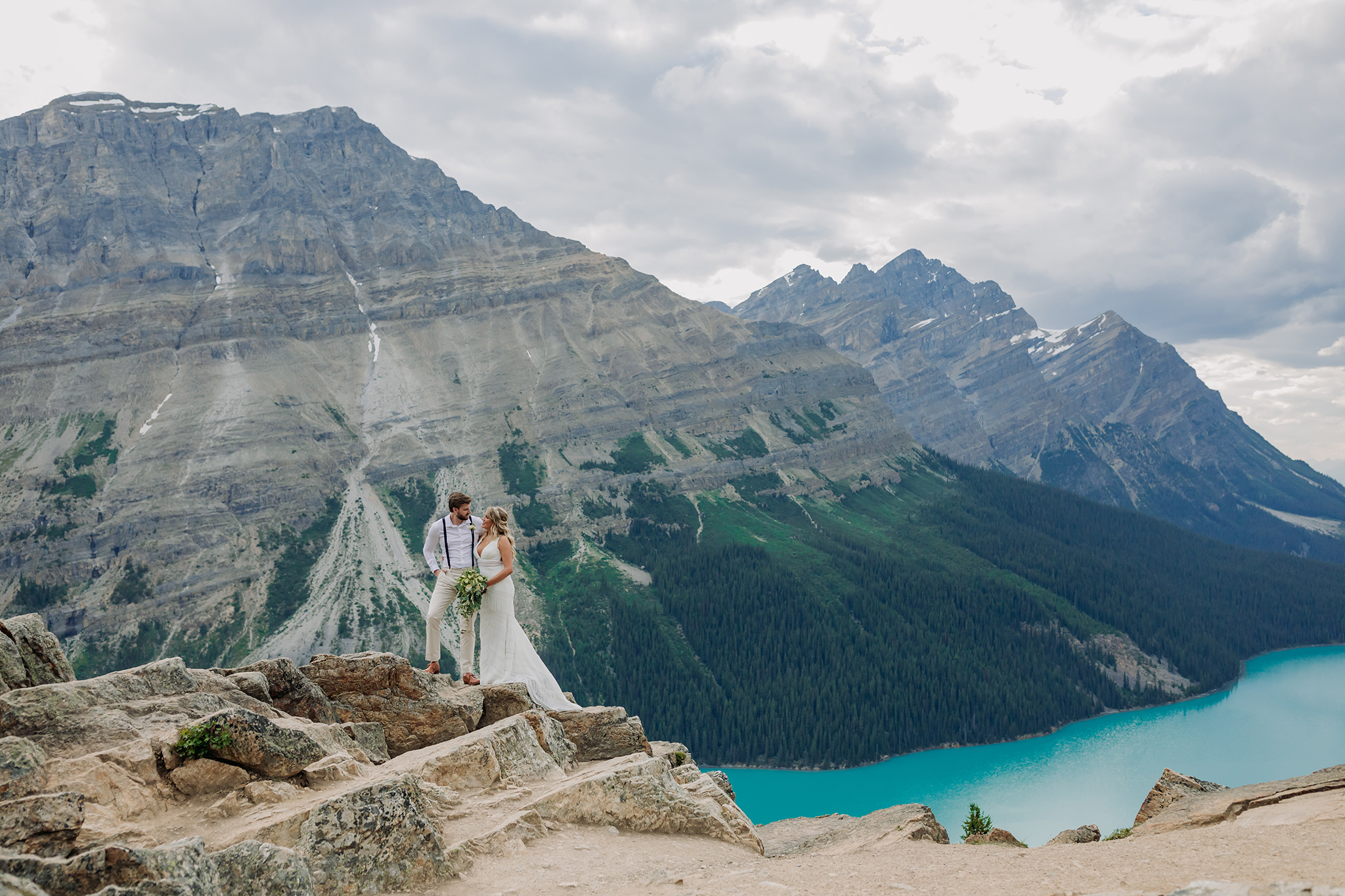 Peyto Lake Intimate wedding portraits on Icefields Parkway surrounded by Mountains overlooking blue mountain Lake in the summer photographed my ENV Photography