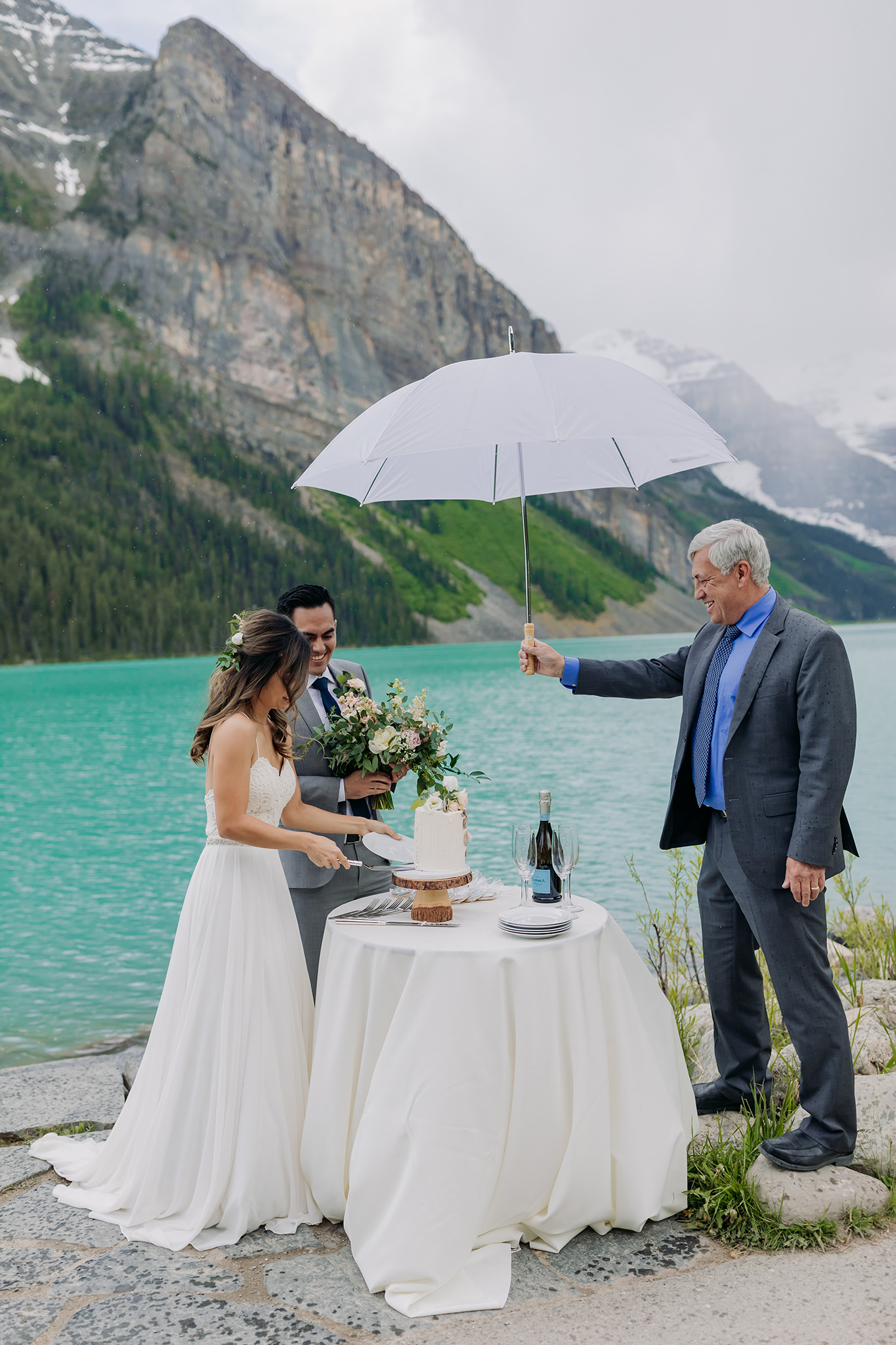 Lake Louise lakeshore wedding cake cutting photographed by elopement photographer ENV Photography