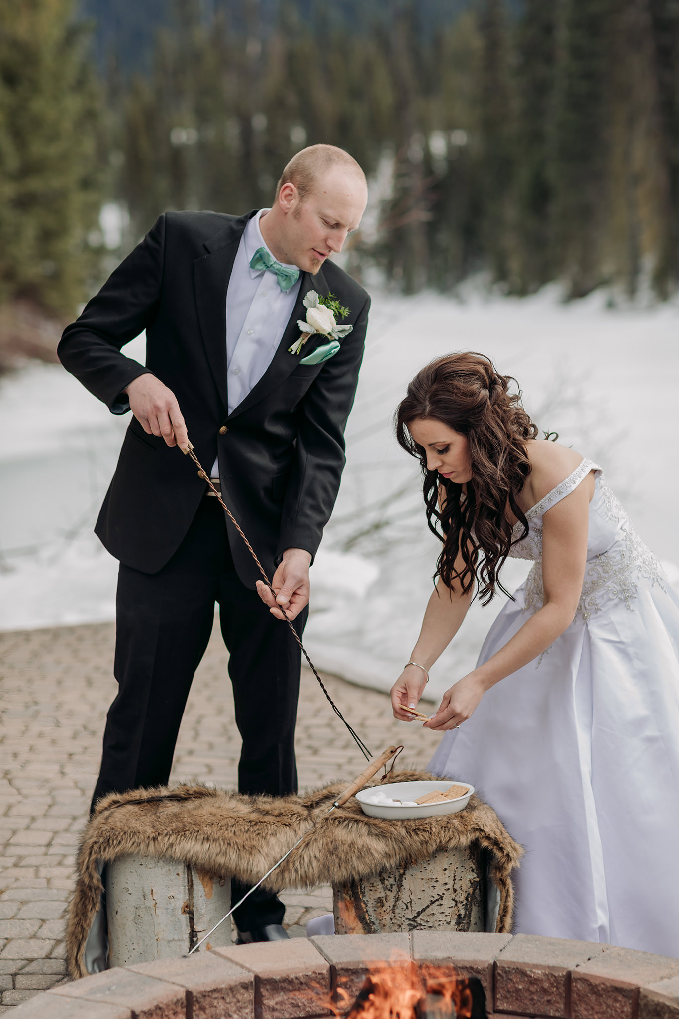emerald lake lodge wedding on patio at Cilantro on the Lake roasting s'mores in the fire pit