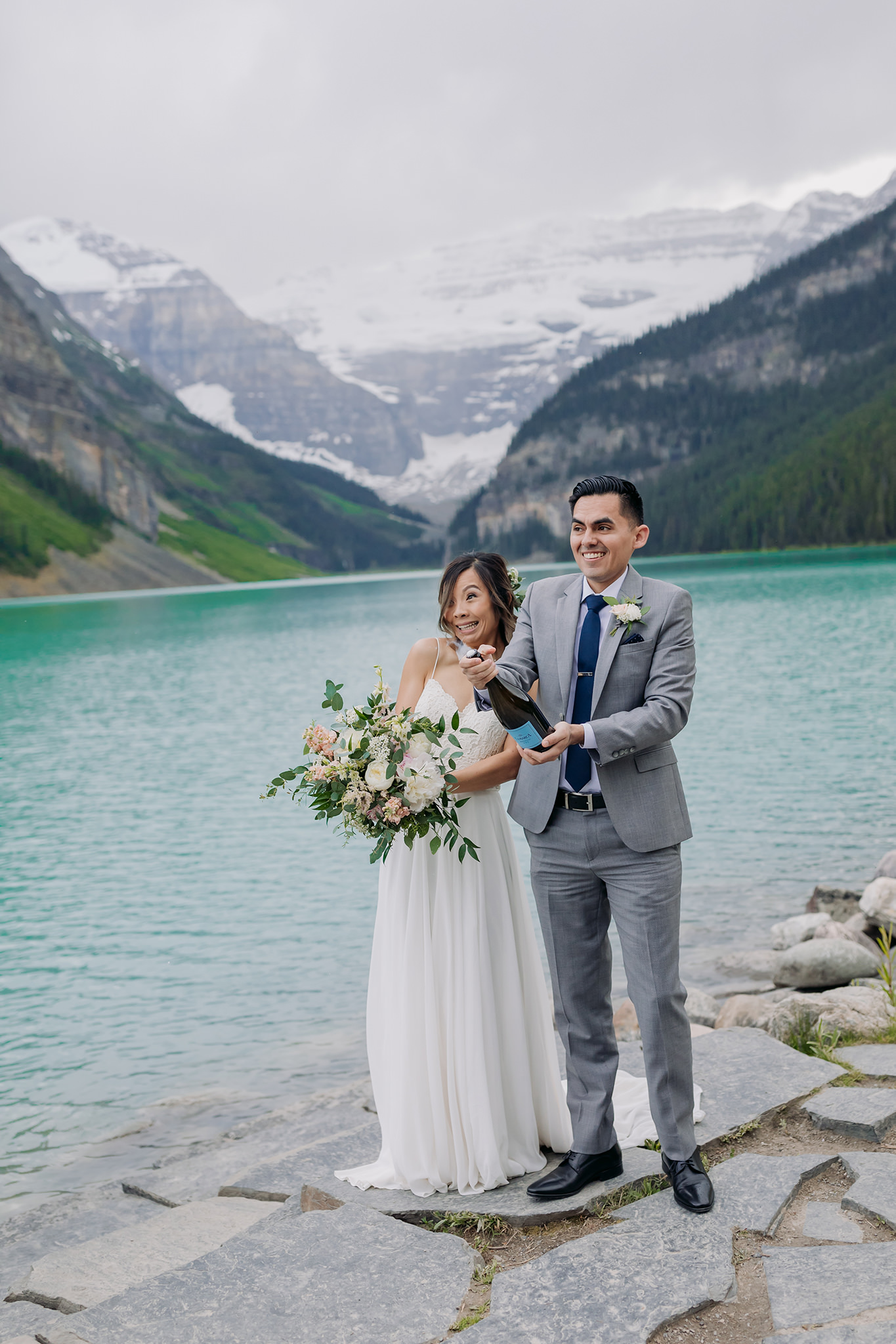 Lake Louise lakeshore wedding champagne toast photographed by elopement photographer ENV Photography