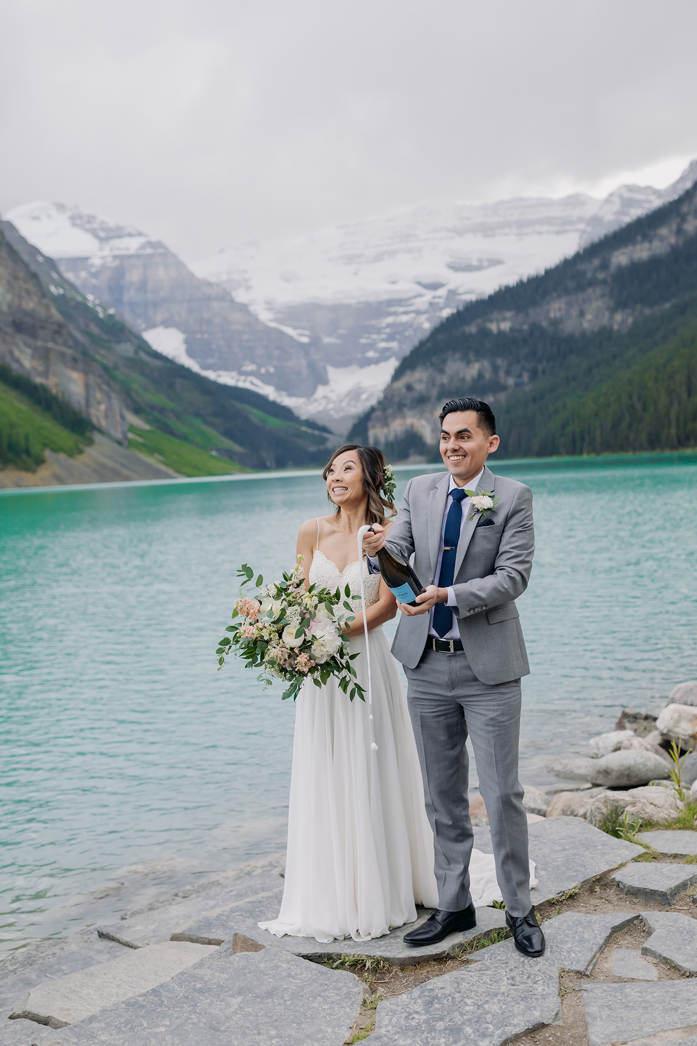 Lake Louise lakeshore wedding champagne toast photographed by elopement photographer ENV Photography