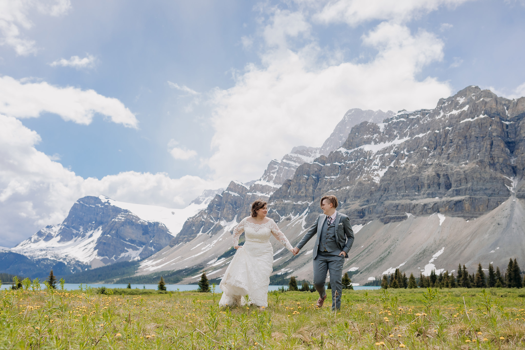Post-wedding portraits in the meadow at Bow Lake. same-sex wedding. Mountain Wedding portraits photographed by ENV Photography. Gay friendly. LGBTQ friendly wedding & elopement photographer.