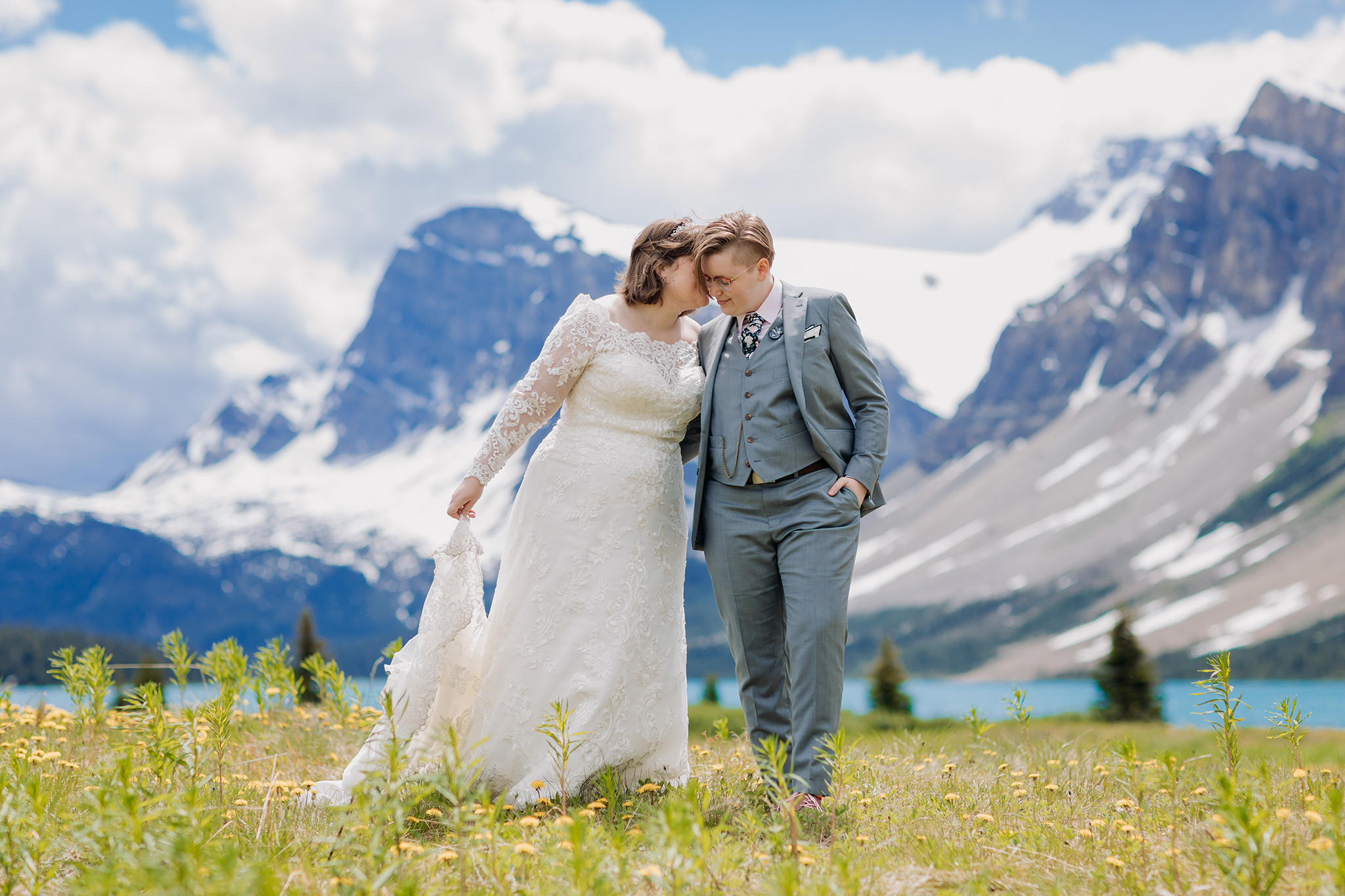 Post-wedding portraits in the meadow at Bow Lake. same-sex wedding. Mountain Wedding portraits photographed by ENV Photography. Gay friendly. LGBTQ friendly wedding & elopement photographer.