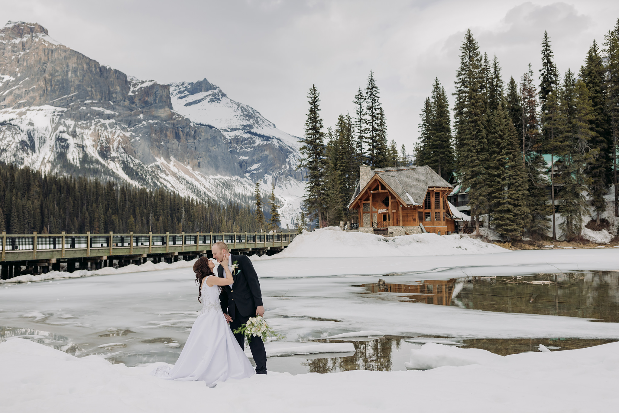 emerald lake lodge wedding spring mountain portraits by open water in the snow