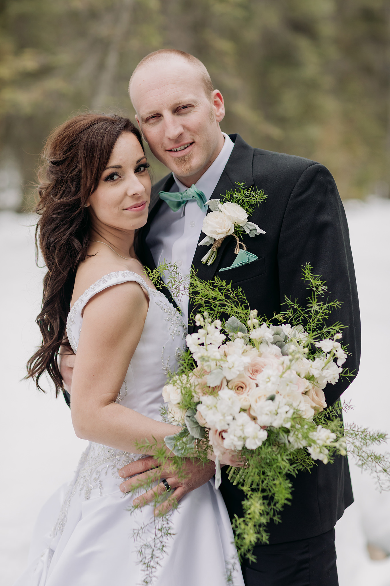 emerald lake lodge wedding spring mountain portraits by open water in the snow